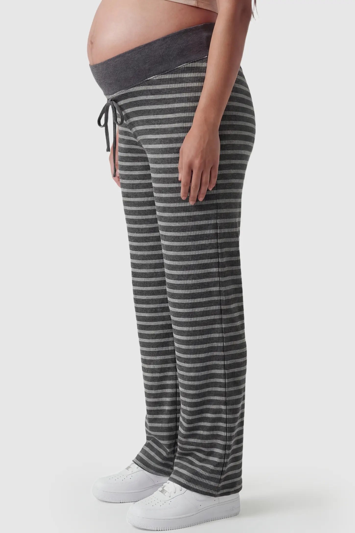 Striped Knit Drawstring Wide-Leg Maternity Pants Striped Knit Drawstring Wide-Leg Maternity Pants in light stripes featuring a draped, wide-leg cut on a pregnant model, side view.