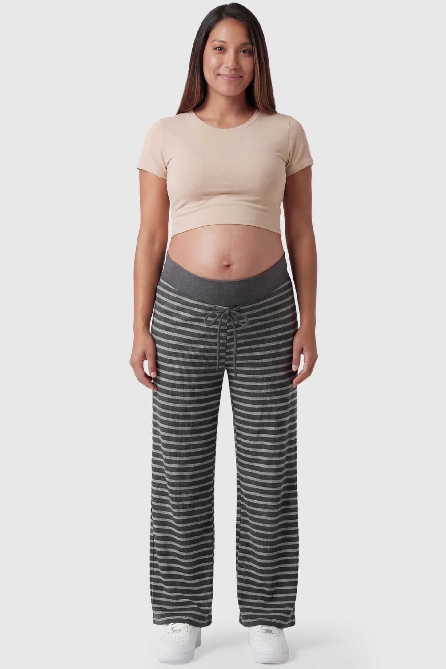 Striped Knit Drawstring Wide-Leg Maternity Pants Striped Knit Drawstring Wide-Leg Maternity Pants in light stripes featuring a soft, skin-friendly texture on a pregnant model, in full body shot.