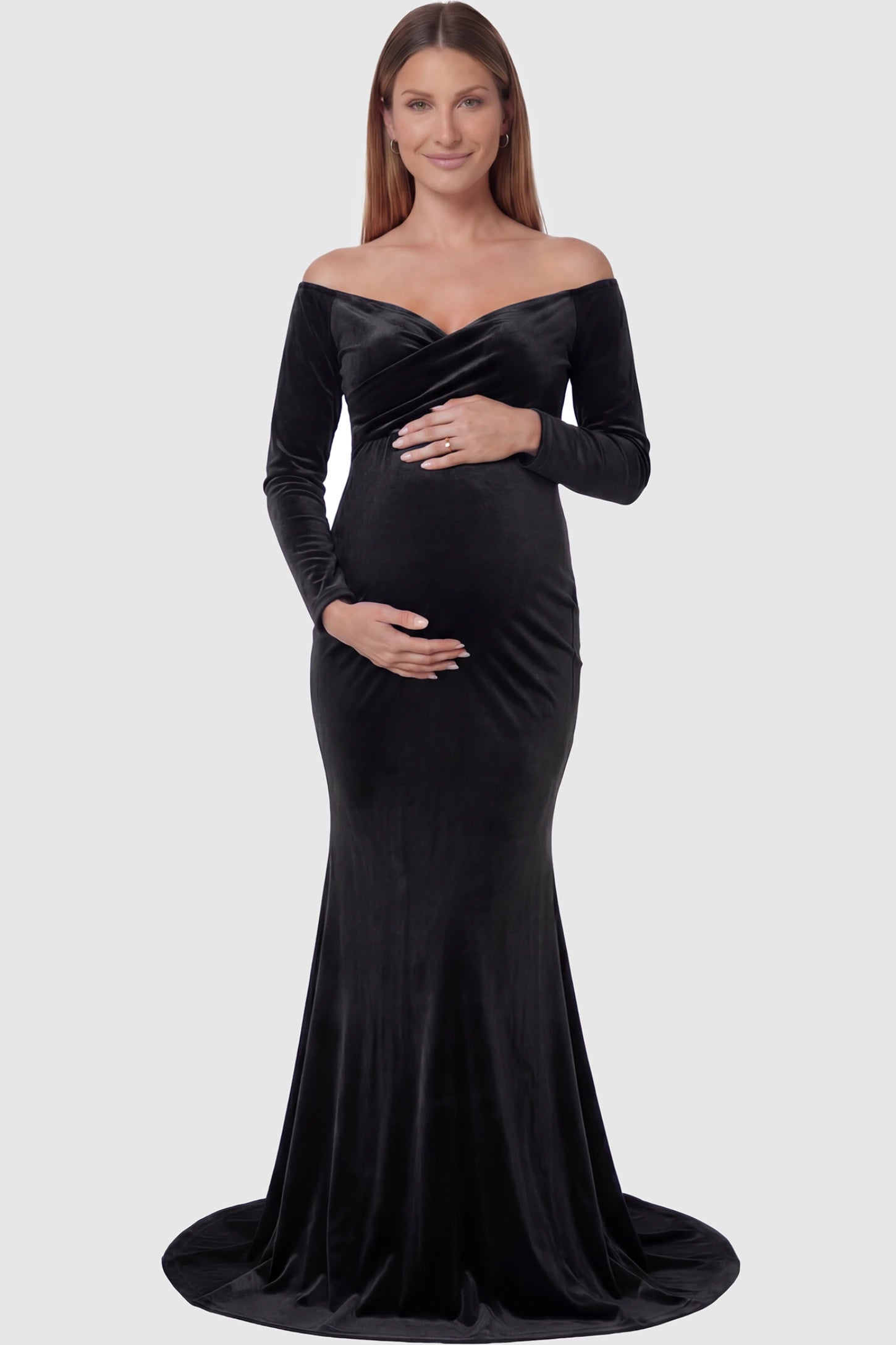 Velvet Long Fitted Sleeve Maternity Gown Velvet Long Fitted Sleeve Maternity Gown in black featuring an off-shoulder sweetheart neckline, draped bust, empire waist, and mermaid skirt on pregnant model front view.