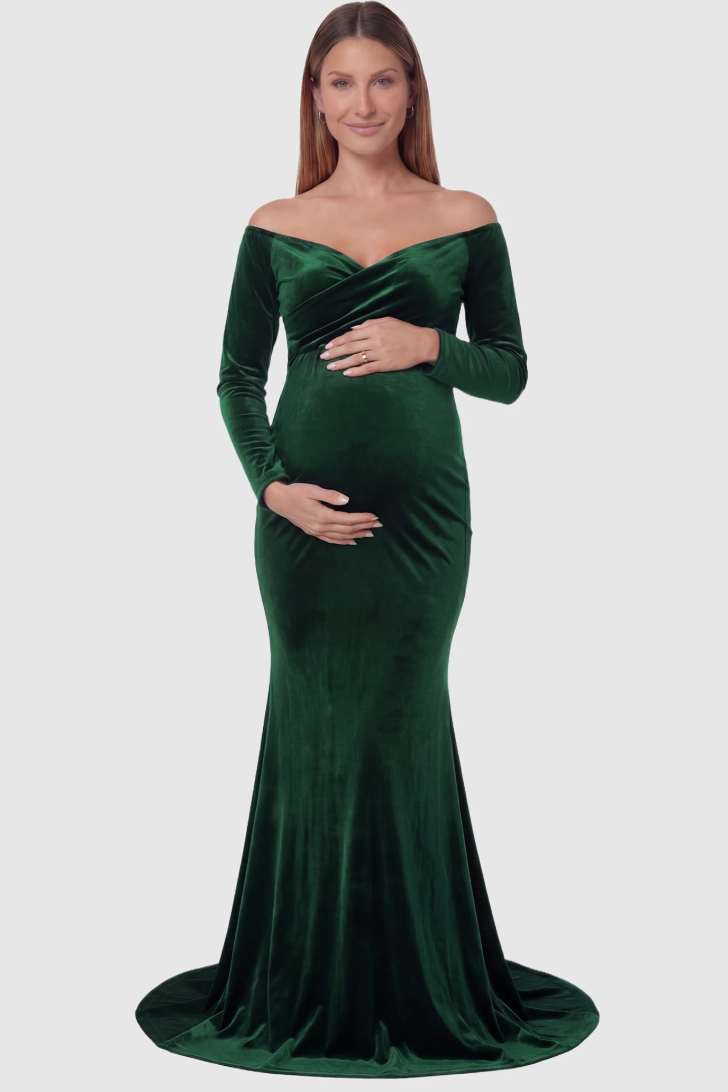 Velvet Long Fitted Sleeve Maternity Gown Velvet Long Fitted Sleeve Maternity Gown in green featuring an off-shoulder sweetheart neckline, draped bust, empire waist, and mermaid skirt on pregnant model front view.
