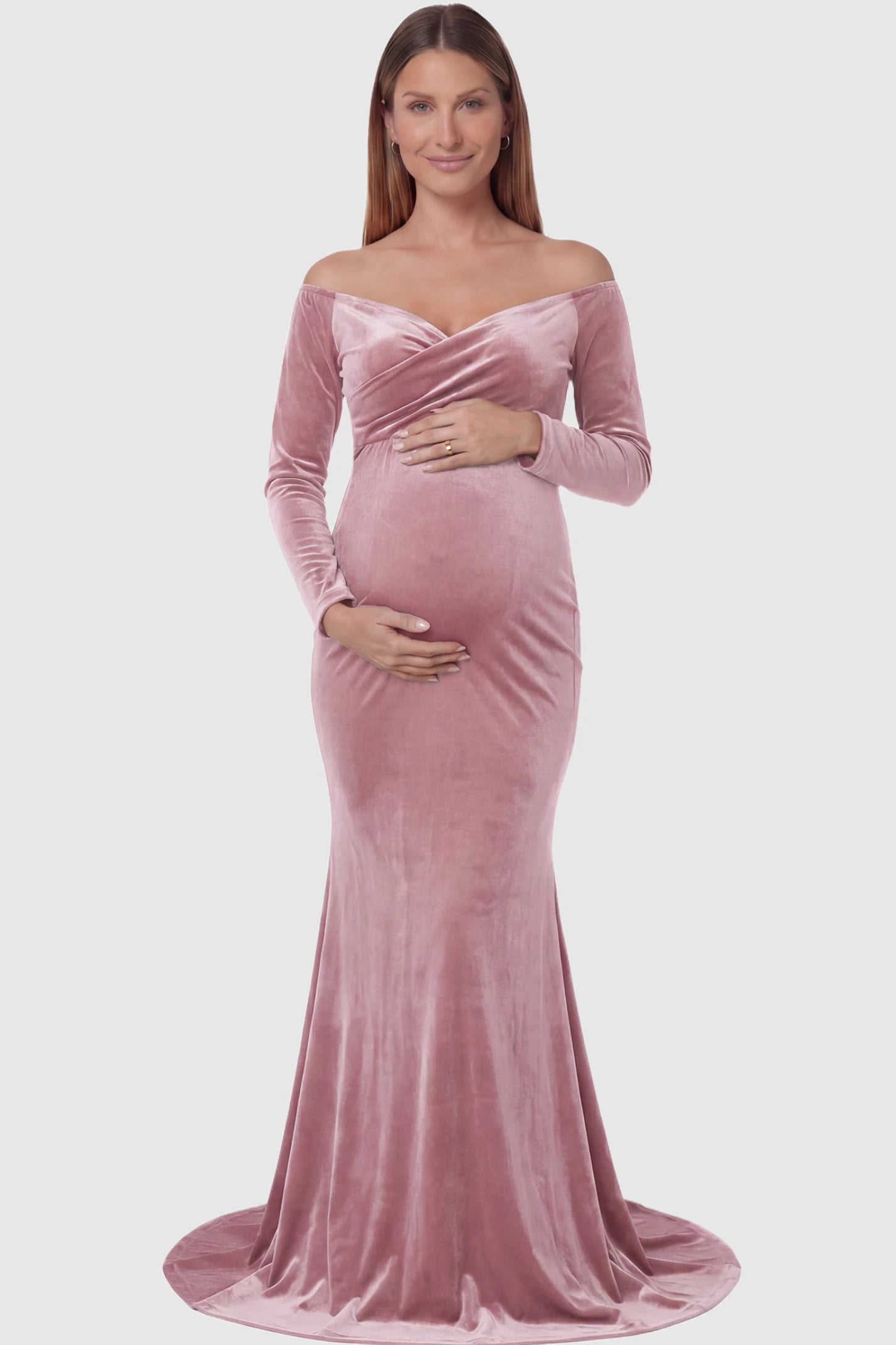 Velvet Long Fitted Sleeve Maternity Gown in pink featuring an off-shoulder sweetheart neckline, draped bust, empire waist, and mermaid skirt on pregnant model front view.