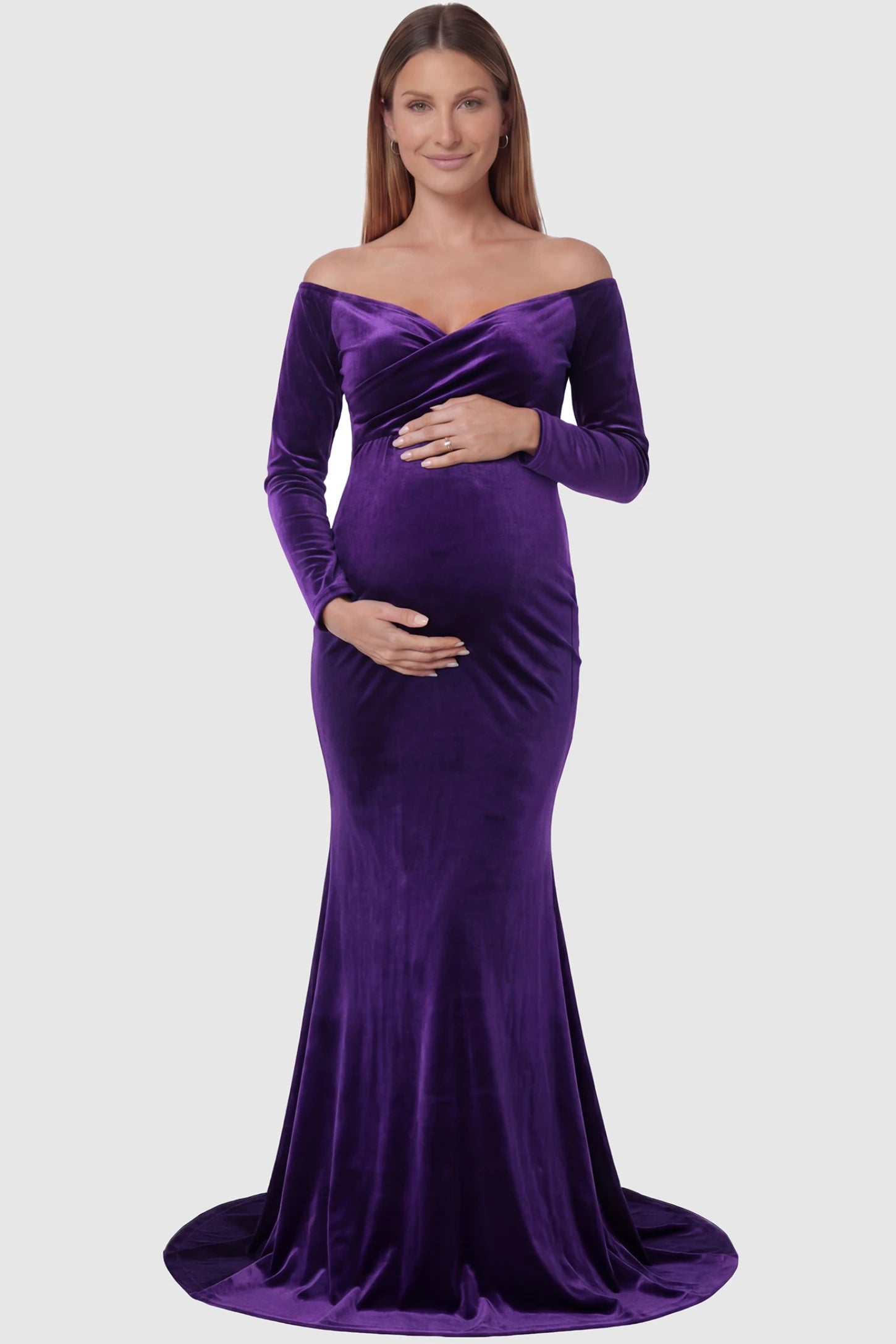 Velvet Long Fitted Sleeve Maternity Gown Velvet Long Fitted Sleeve Maternity Gown in purple featuring an off-shoulder sweetheart neckline, draped bust, empire waist, and mermaid skirt on pregnant model front view.