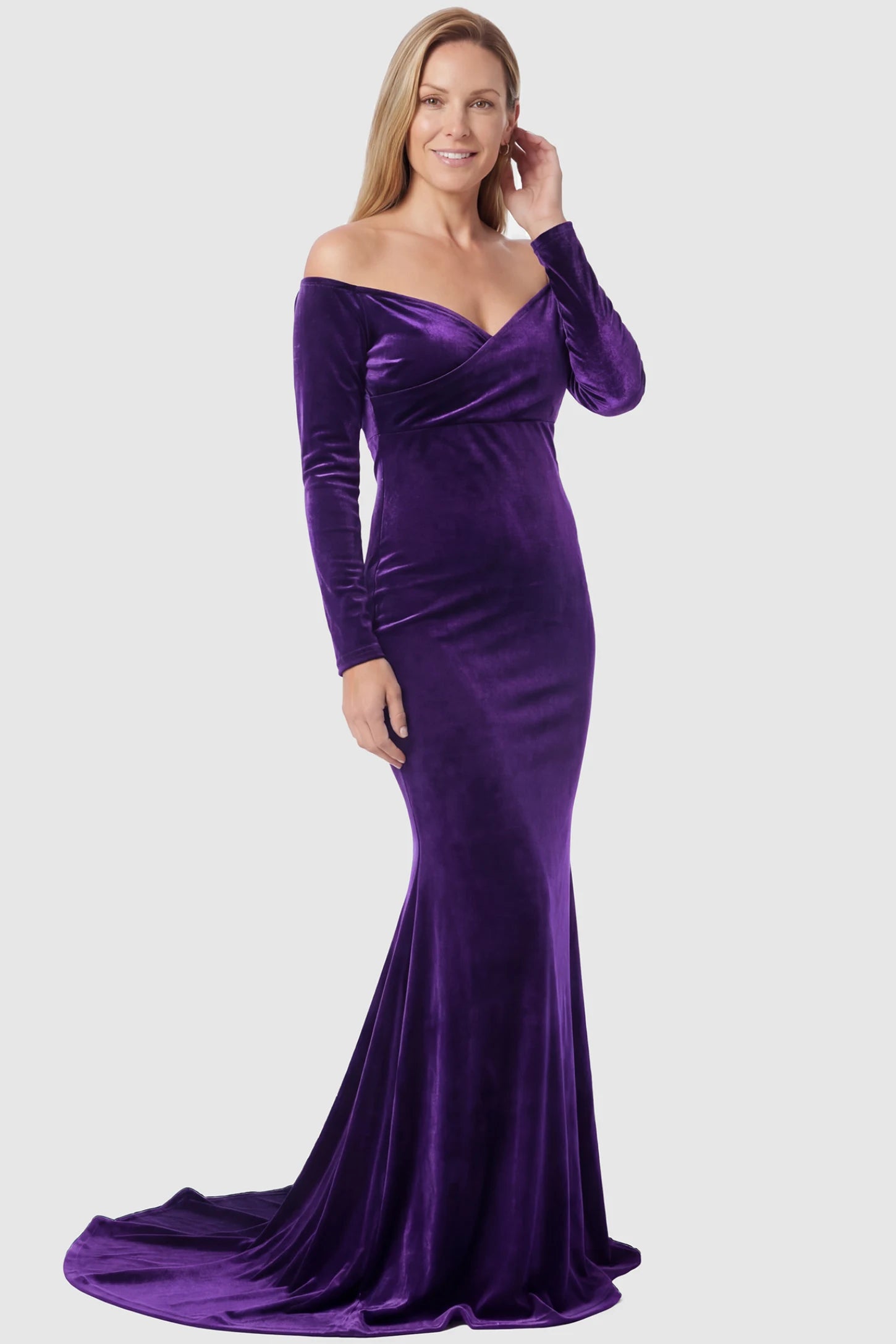 Velvet Long Fitted Sleeve Maternity Gown Velvet Long Fitted Sleeve Maternity Gown in purple featuring an off-shoulder sweetheart neckline, draped bust, empire waist, and mermaid skirt on non pregnant model.