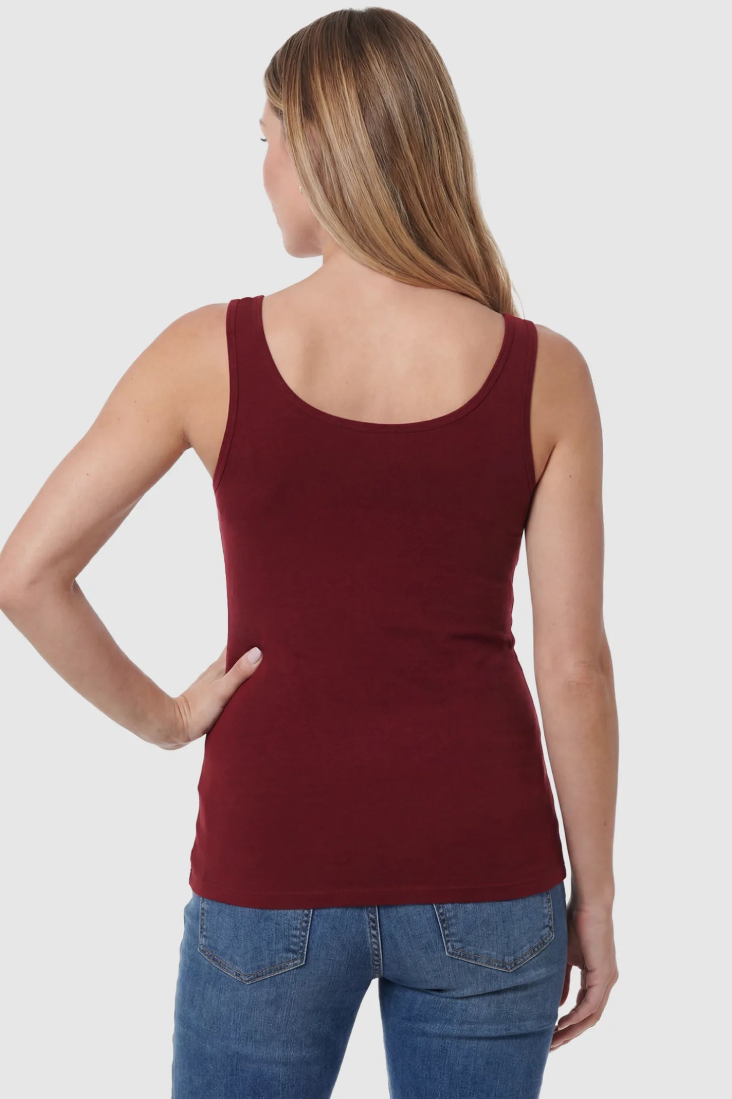 Basic Maternity & Nursing Tank Top Basic Maternity & Nursing Tank Top in burgundy featuring a scoop neck and smooth, body-hugging fit on a pregnant model, back view.