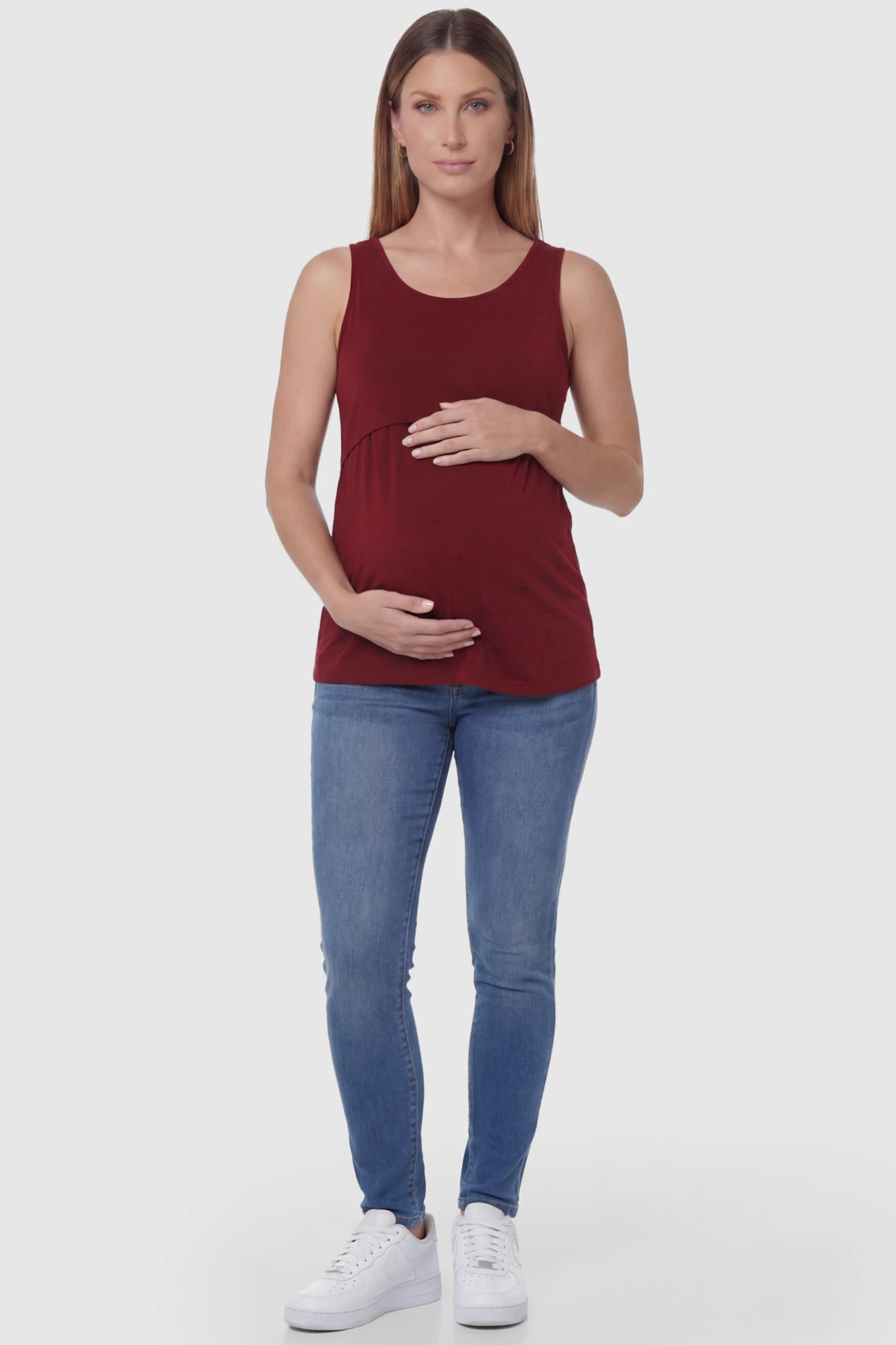 Basic Maternity & Nursing Tank Top Basic Maternity & Nursing Tank Top in burgundy featuring a scoop neck and smooth, body-hugging fit on a pregnant model, full body view.