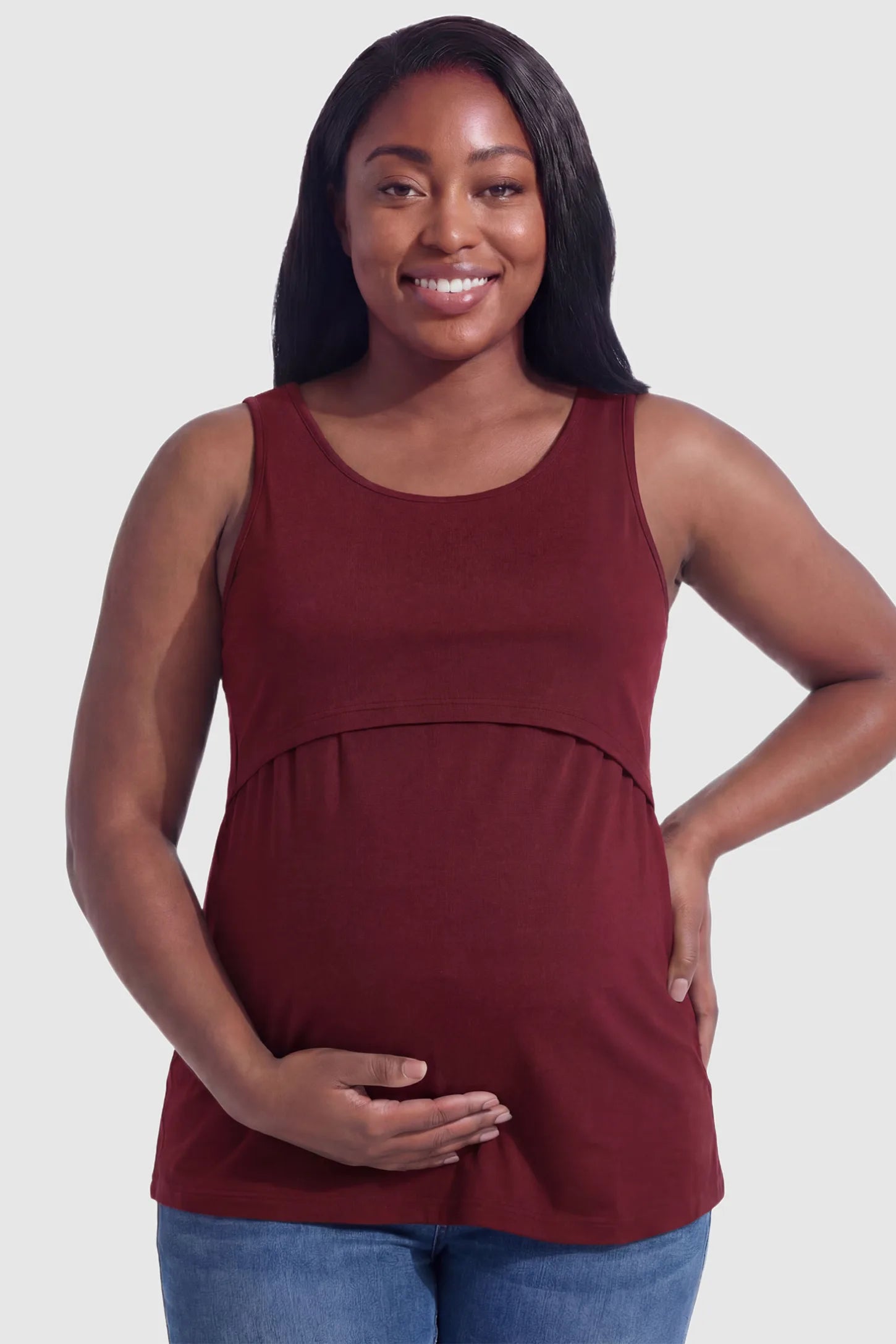 Basic Maternity & Nursing Tank Top Basic Maternity & Nursing Tank Top in burgundy featuring a scoop neck and smooth, body-hugging fit on a plus size pregnant model, front view.