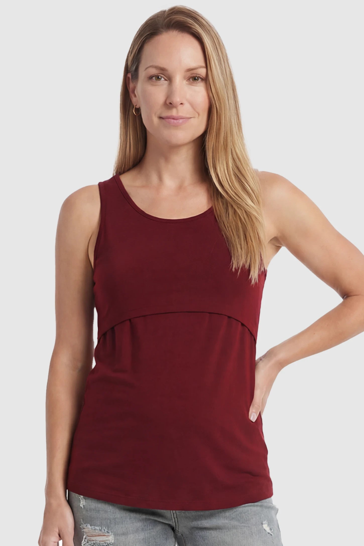 Basic Maternity & Nursing Tank Top Basic Maternity & Nursing Tank Top in burgundy featuring a scoop neck and smooth, body-hugging fit on a postpartum model, front view.