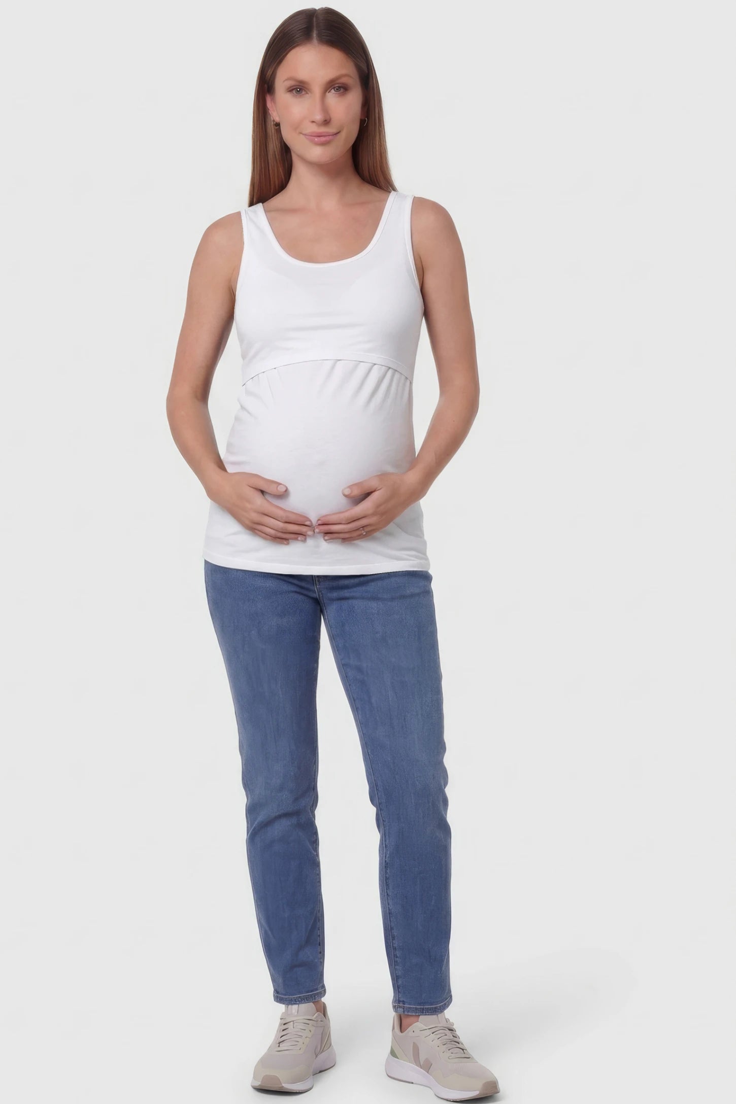 Basic Maternity & Nursing Tank Top Basic Maternity & Nursing Tank Top in white featuring a scoop neck and smooth, body-hugging fit on a pregnant model.