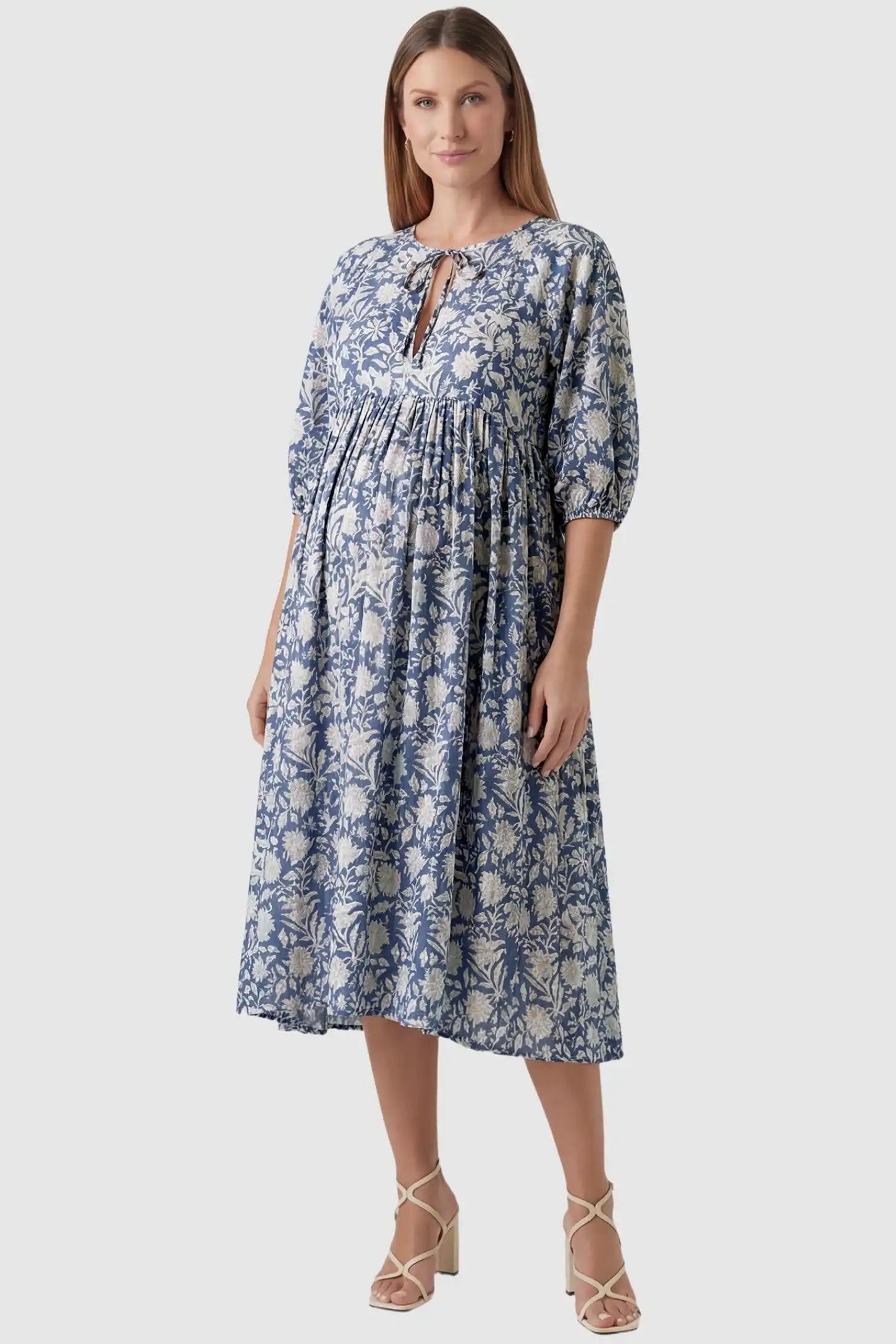 Floral Tie Neck Lantern Sleeve Maternity Midi Dress Floral Tie Neck Lantern Sleeve Maternity Midi Dress in Dark Blue featuring a keyhole neckline on a pregnant model.