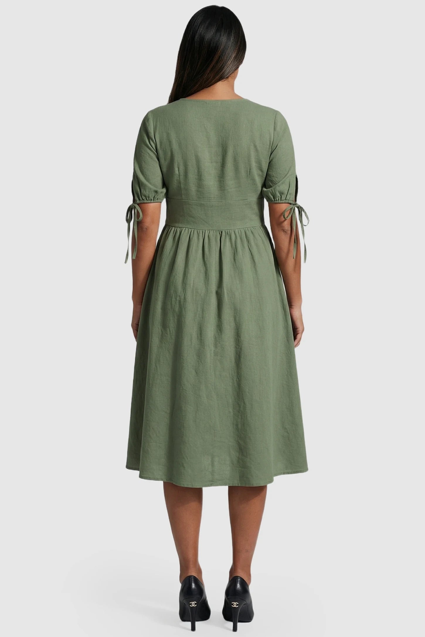 Tie-Sleeve V-Neck Flared Maternity Midi Dress Tie-Sleeve V-Neck Flared Maternity Midi Dress in Green featuring adjustable sleeve ties on a pregnant model.