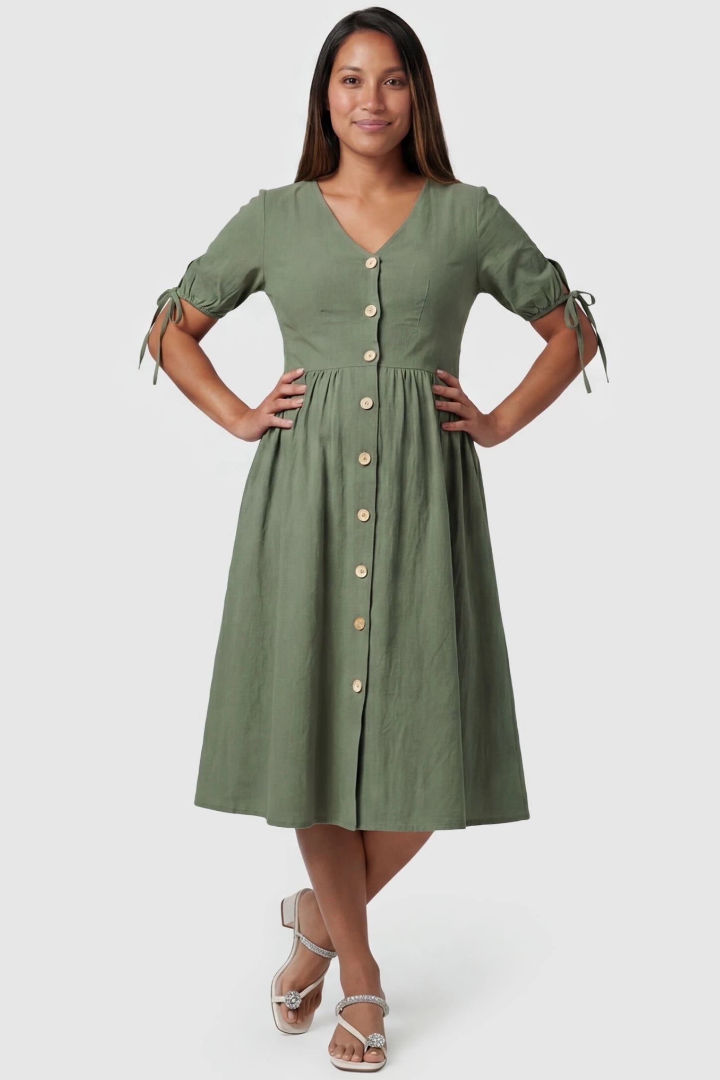 Tie-Sleeve V-Neck Flared Maternity Midi Dress Front view Tie-Sleeve V-Neck Flared Maternity Midi Dress in Green featuring a button front on a pregnant model.