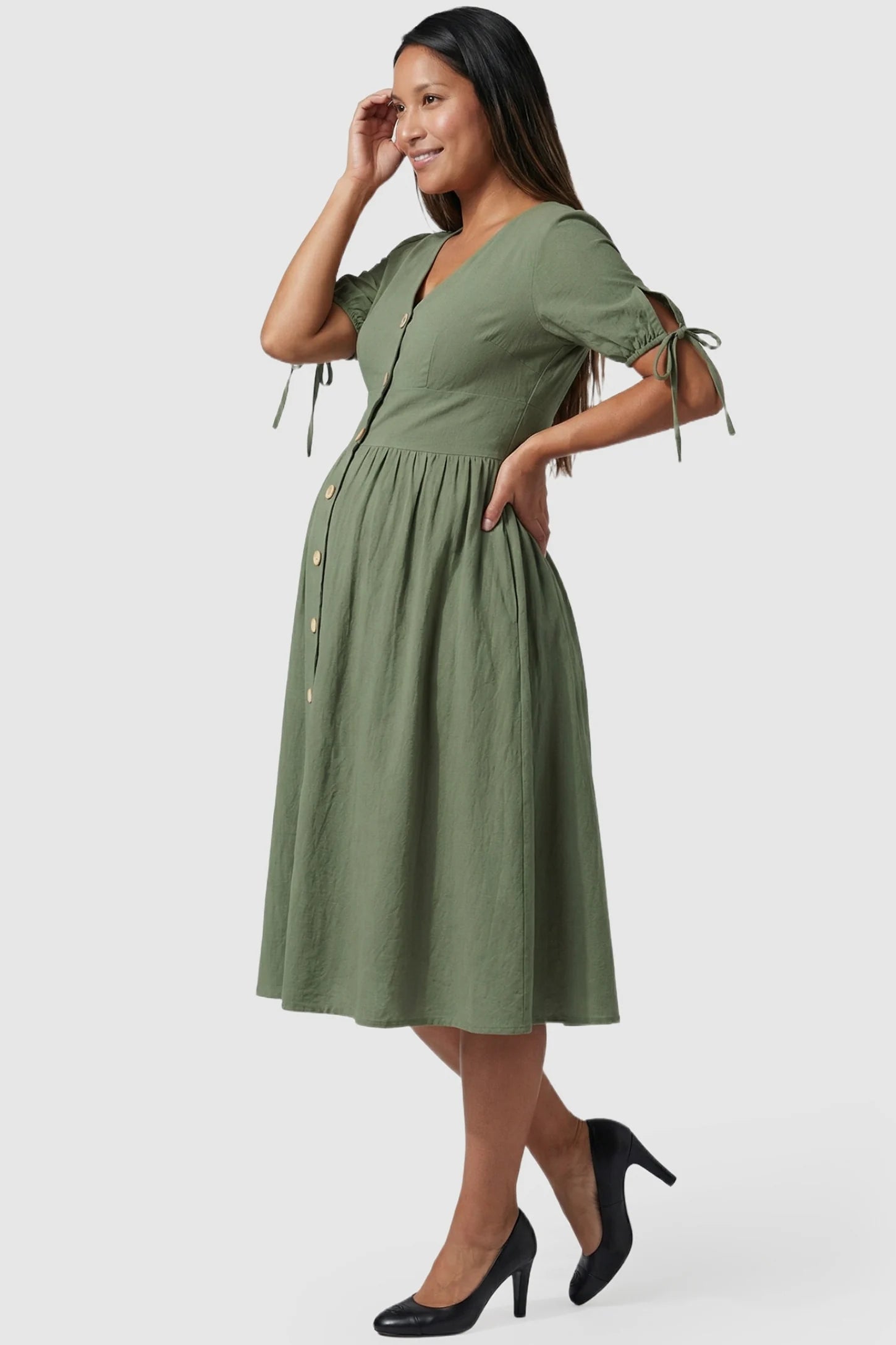 Tie-Sleeve V-Neck Flared Maternity Midi Dress Tie-Sleeve V-Neck Flared Maternity Midi Dress in Green featuring a flared skirt profile on a pregnant model.