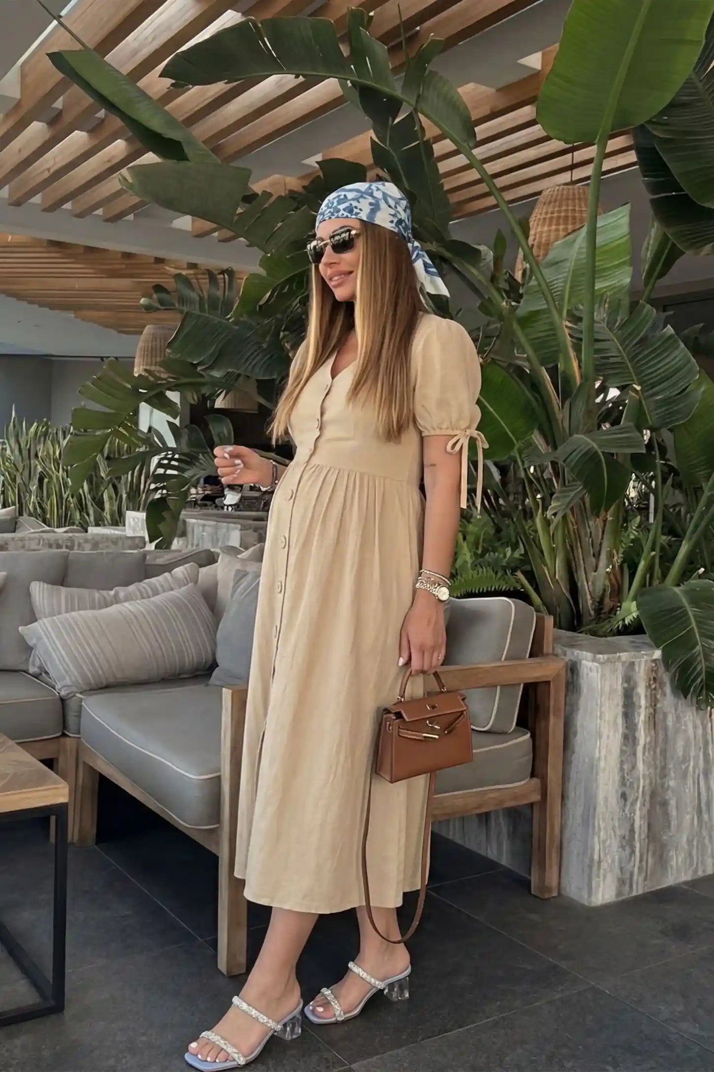 Side view Tie-Sleeve V-Neck Flared Maternity Midi Dress in Apricot featuring an empire waist on a pregnant model.