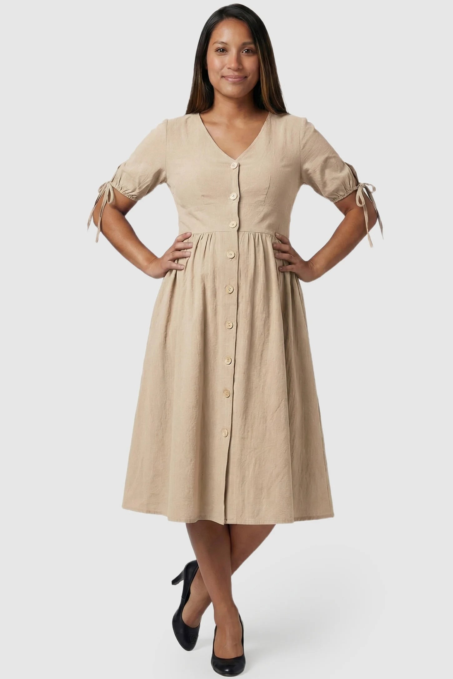 Tie-Sleeve V-Neck Flared Maternity Midi Dress in Apricot featuring a button-front design on a pregnant model.