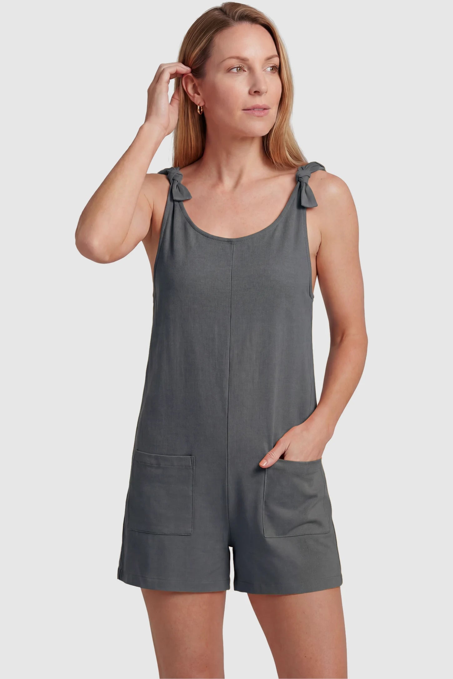 Tie-Strap Sleeveless Pocketed Maternity Romper Tie-strap sleeveless pocketed maternity romper in gray with adjustable tie straps and scoop neckline, front view on postpartum model