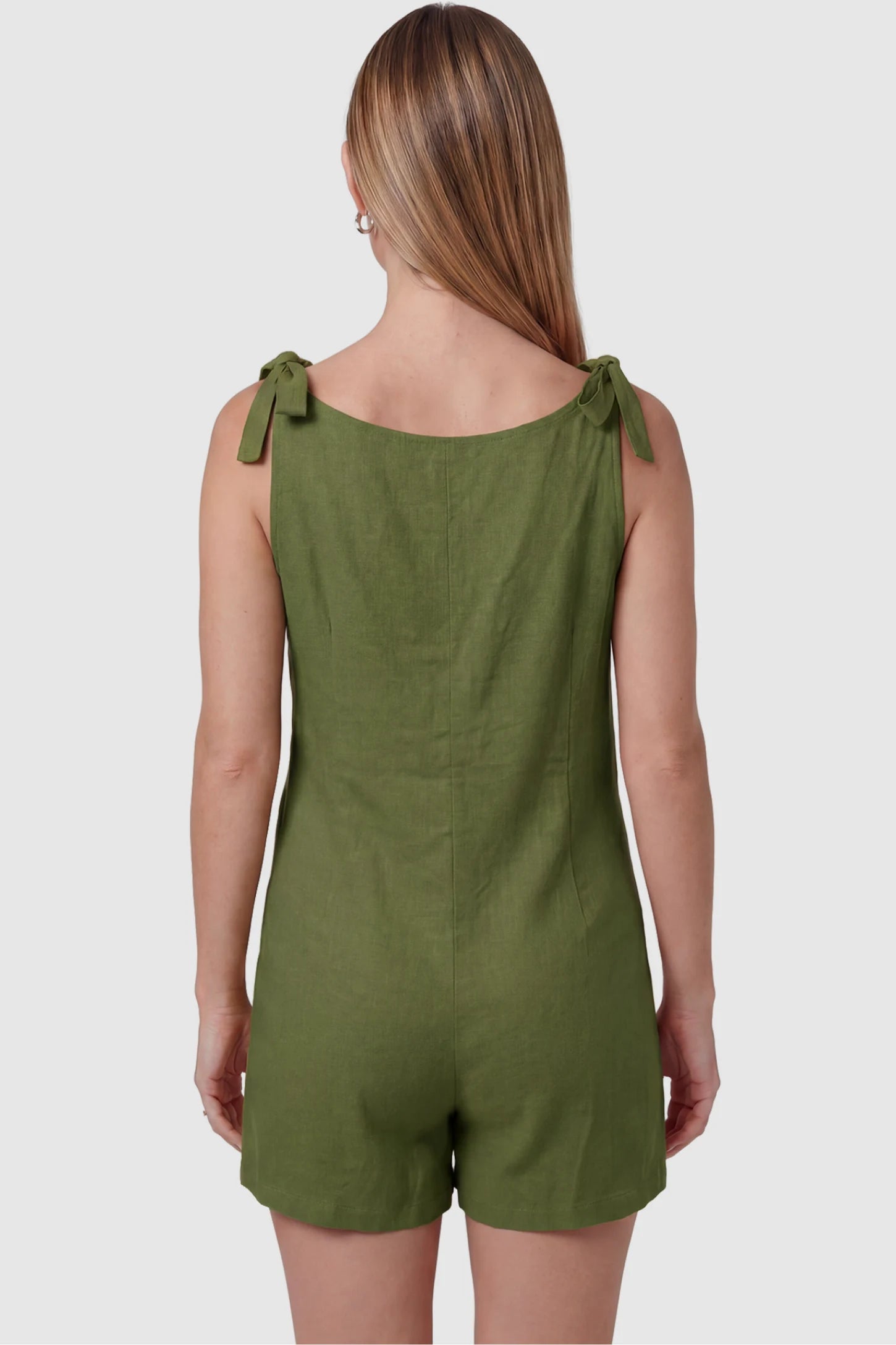 Tie-Strap Sleeveless Pocketed Maternity Romper Tie-strap sleeveless pocketed maternity romper in green with adjustable tie straps, back view on pregnant model
