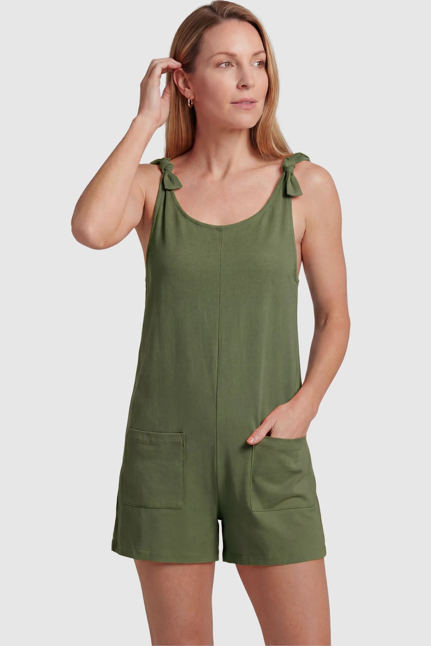 Tie-Strap Sleeveless Pocketed Maternity Romper Tie-strap sleeveless pocketed maternity romper in green with adjustable tie straps and scoop neckline, front view on postpartum model