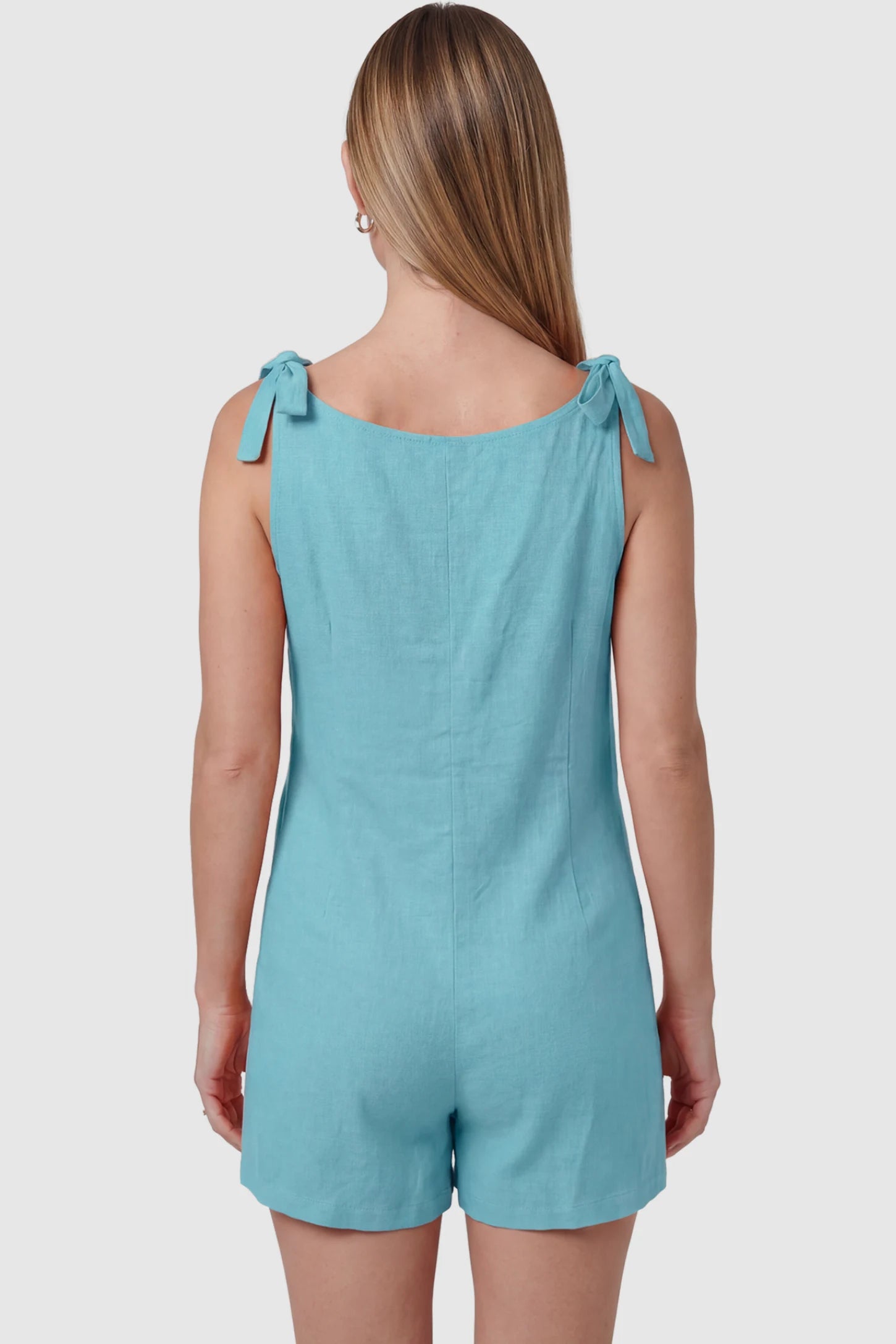 Tie-Strap Sleeveless Pocketed Maternity Romper Tie-strap sleeveless pocketed maternity romper in sky blue with adjustable tie straps, back view on pregnant model