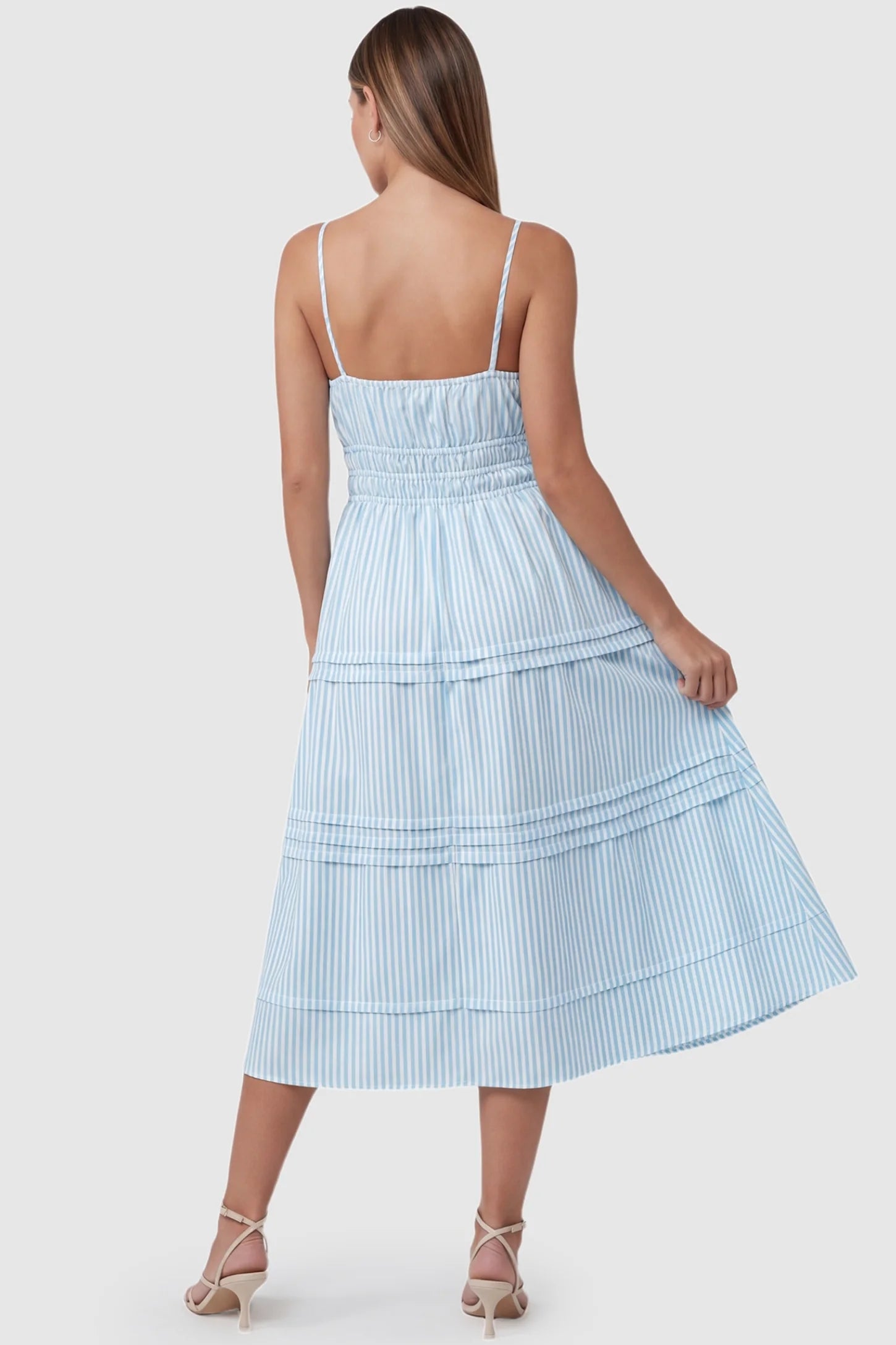 Striped Tie-Front Tiered Maternity Midi Dress Striped Tie-Front Maternity Midi Dress in Blue Striped featuring a smocked back on a pregnant model.