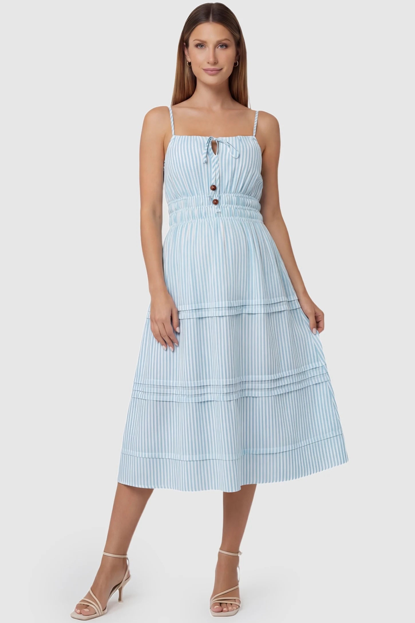 Striped Tie-Front Maternity Midi Dress in Blue Striped featuring a button detail on a front-facing pregnant model.