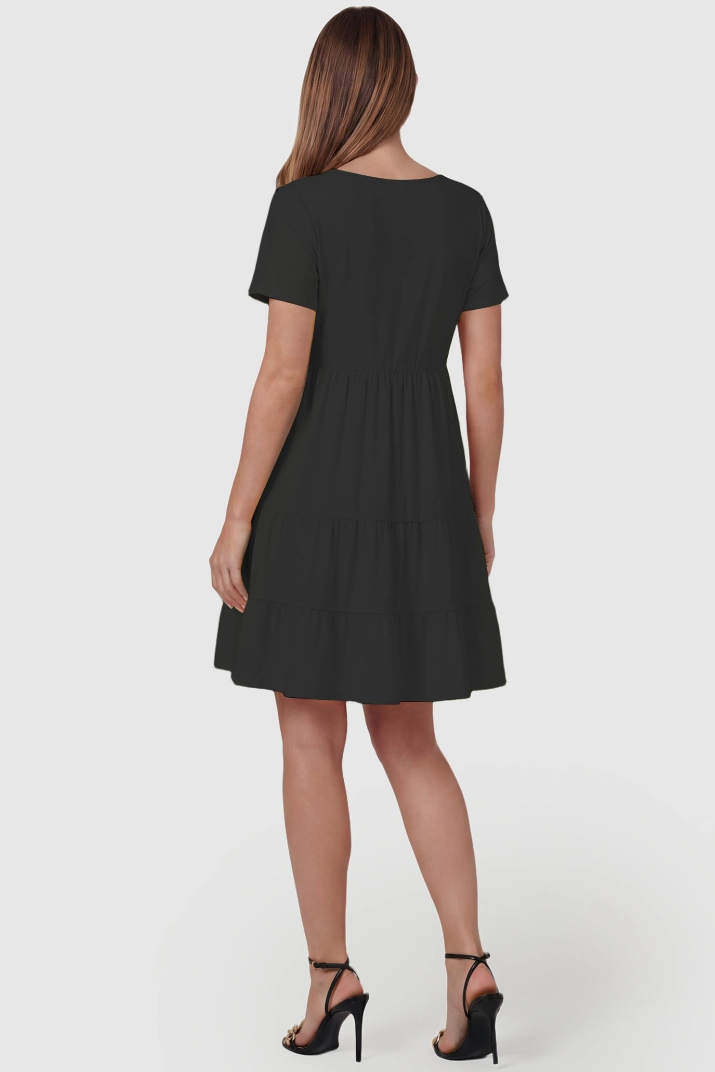 Tiered Button-Front A-Line Maternity Summer Dress Tiered Button-Front A-Line Maternity Summer Dress in Black featuring a classic tiered design on a pregnant model, back view.