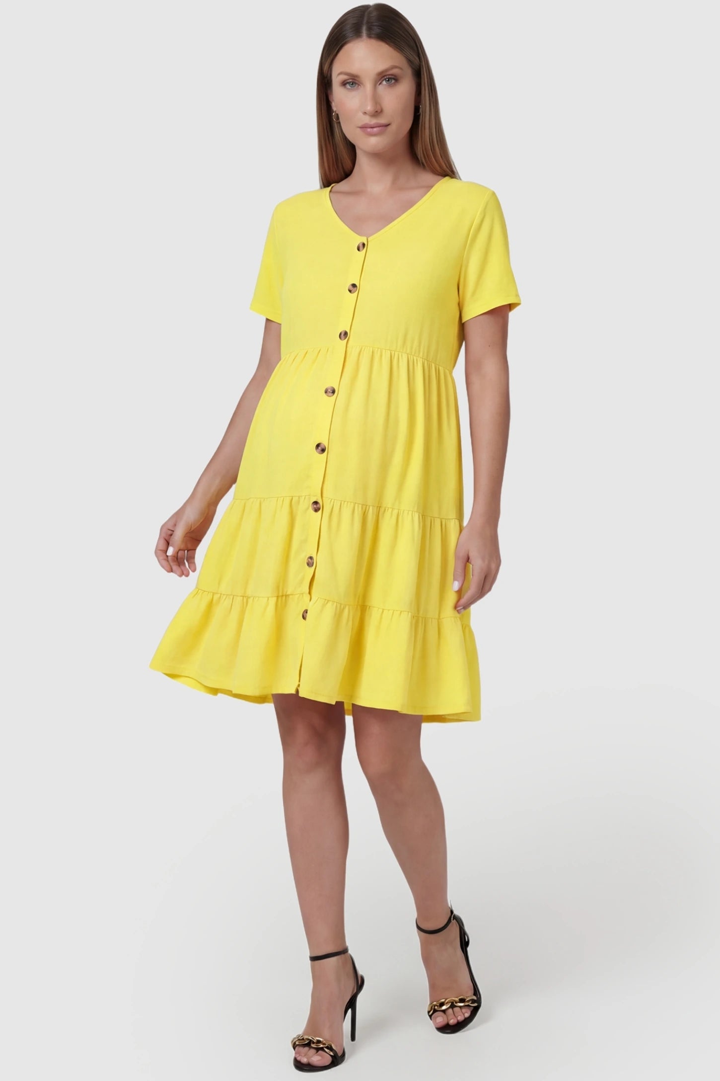Tiered Button-Front A-Line Maternity Summer Dress Tiered Button-Front A-Line Maternity Summer Dress in Yellow featuring button details on a pregnant model, front view.