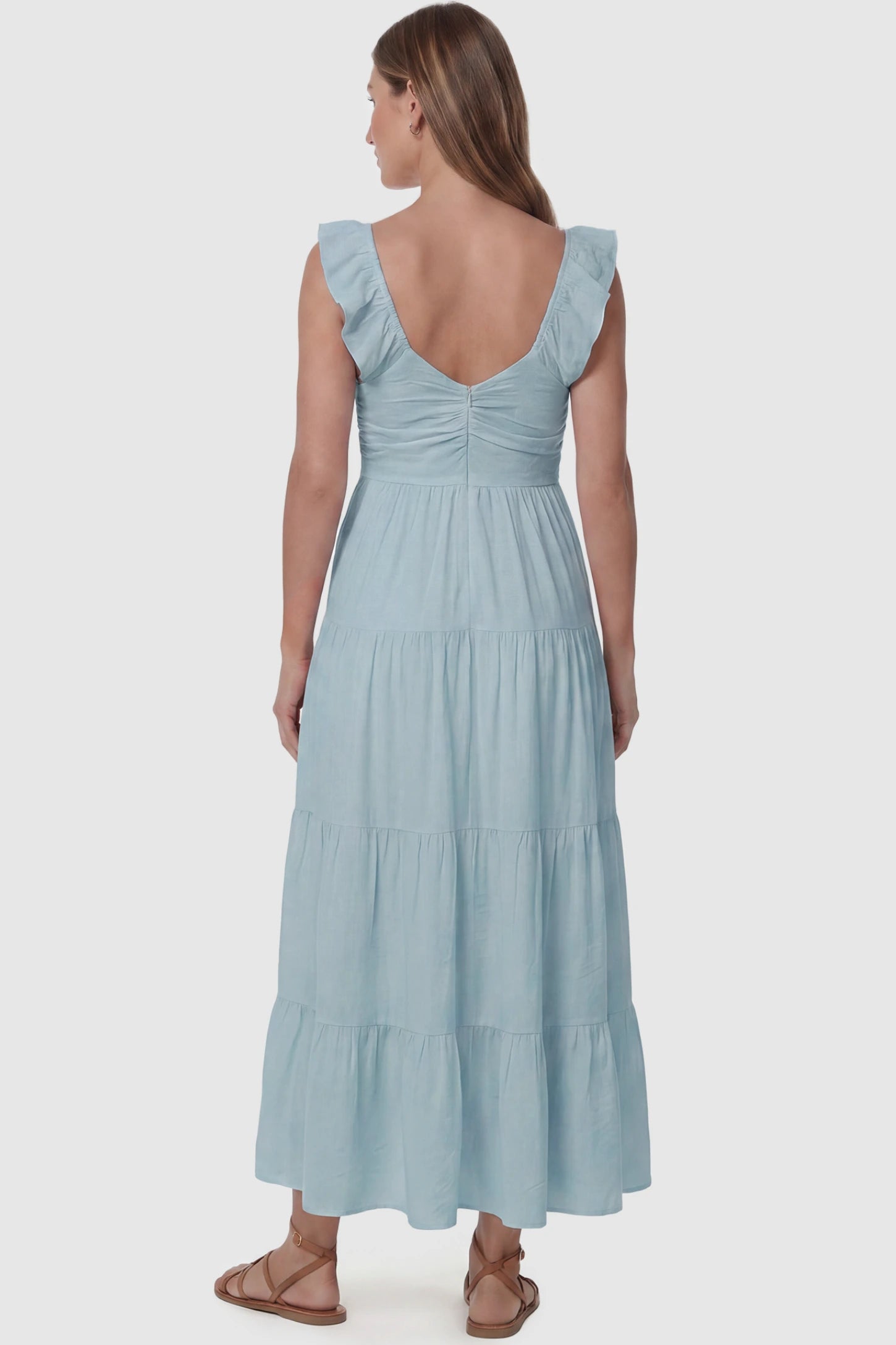 Ruffled Sleeve V-neck A-line Maternity Midi Dress Ruffled sleeve V-neck A-line maternity midi dress in blue with ruffled sleeves and tiered skirt, back view on pregnant model
