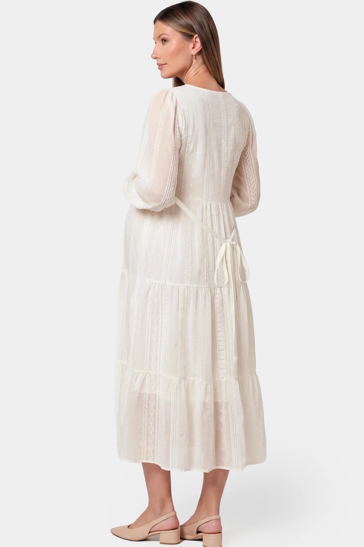 Balloon Sleeve Tiered Maternity Midi Dress Balloon Sleeve Tiered Maternity Midi Dress in off white featuring flowy tiers, back belt, and long balloon sleeves on a pregnant model.