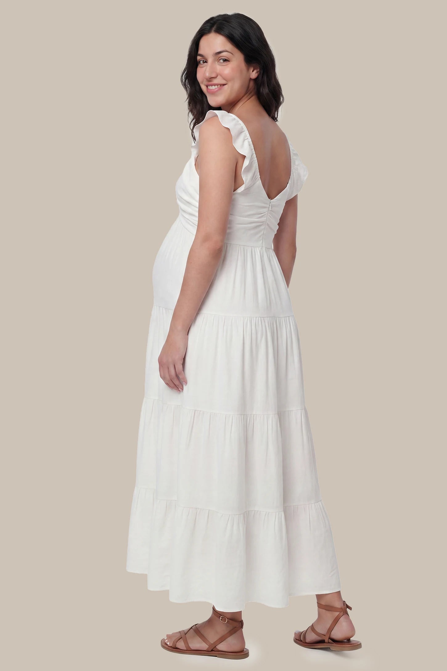 Ruffled Sleeve V-neck A-line Maternity Midi Dress Ruffled sleeve V-neck A-line maternity midi dress in off-white with ruffled sleeves and tiered skirt, back view on pregnant model