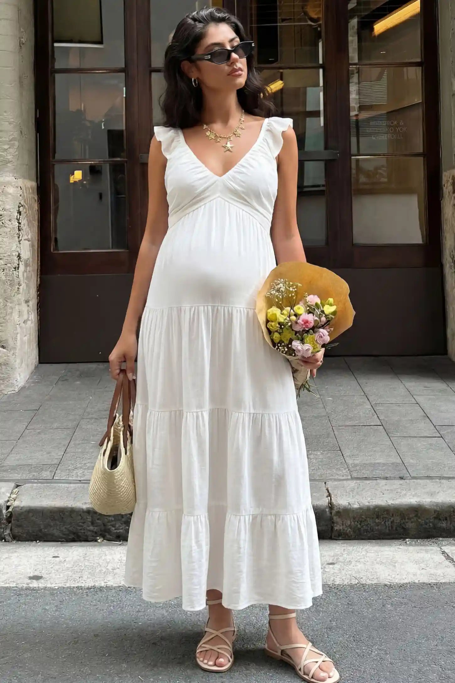 Ruffled sleeve V-neck A-line maternity midi dress in off-white with V-neckline and ruffled sleeves, front view on pregnant model