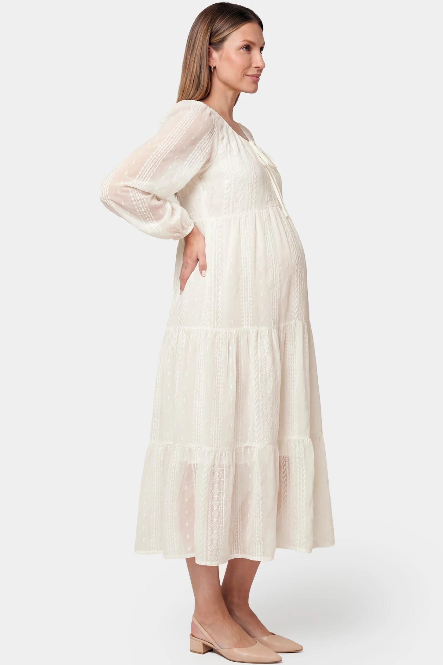 Balloon Sleeve Tiered Maternity Midi Dress in off white featuring flowy tiers and long balloon sleeves on a pregnant model.