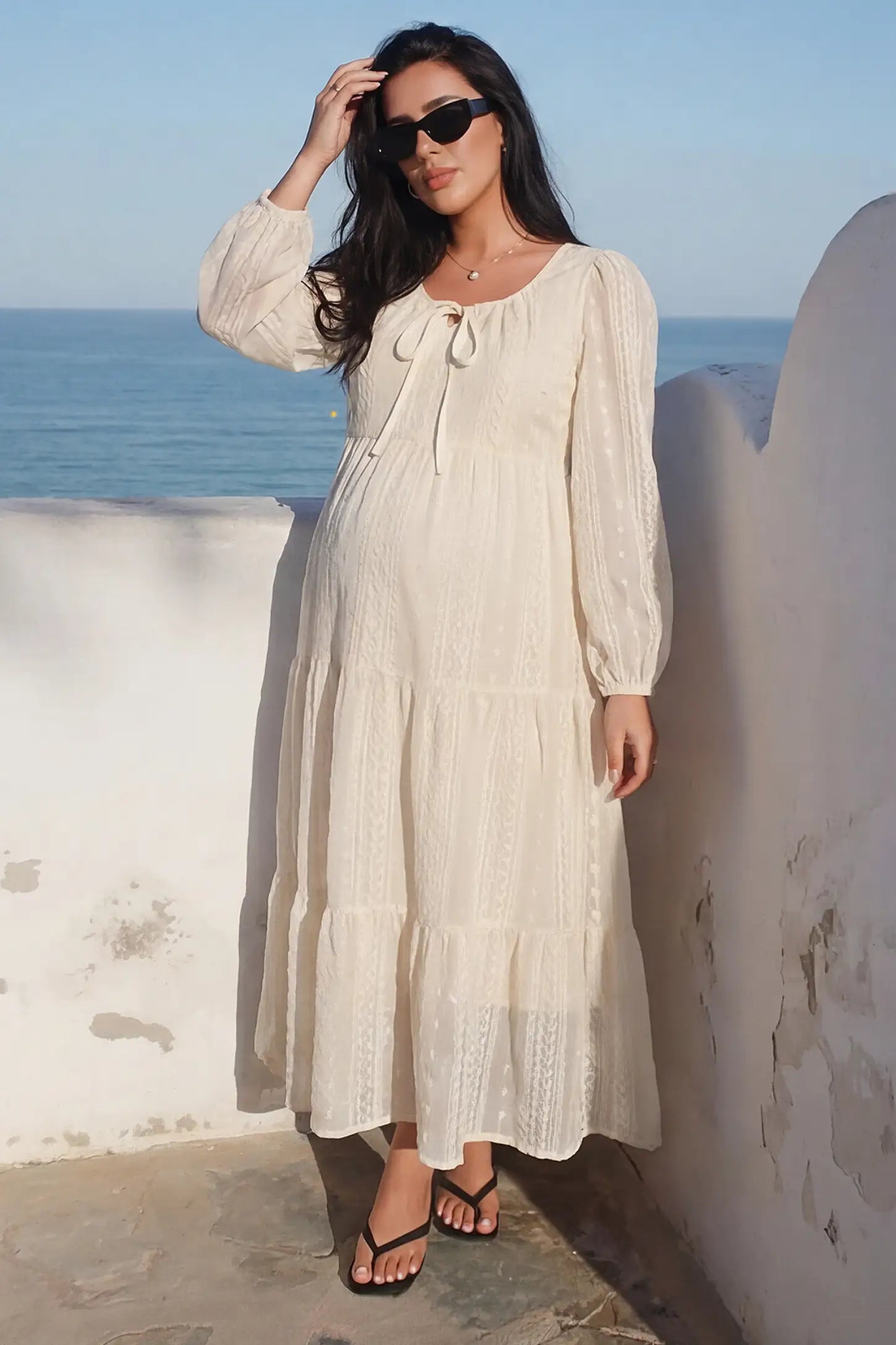 Balloon Sleeve Tiered Maternity Midi Dress Balloon Sleeve Tiered Maternity Midi Dress in off white featuring flowy tiers and long balloon sleeves on a pregnant model front view.