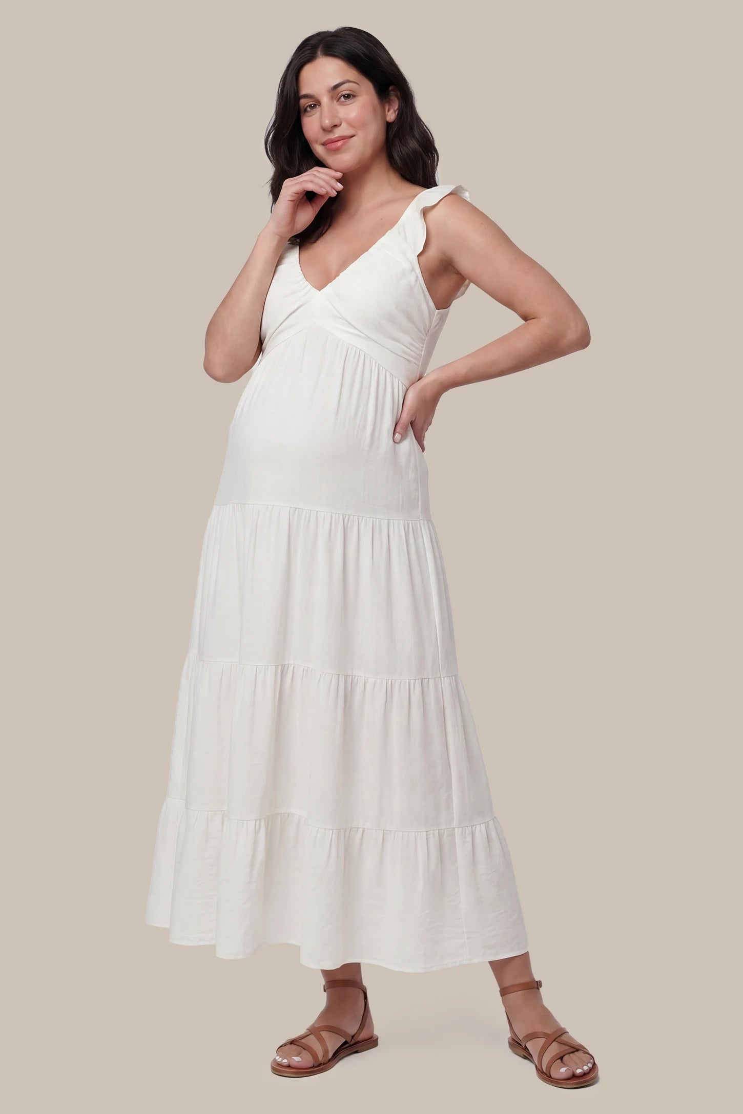 Ruffled sleeve V-neck A-line maternity midi dress in off-white with V-neckline and ruffled sleeves, front view on pregnant model