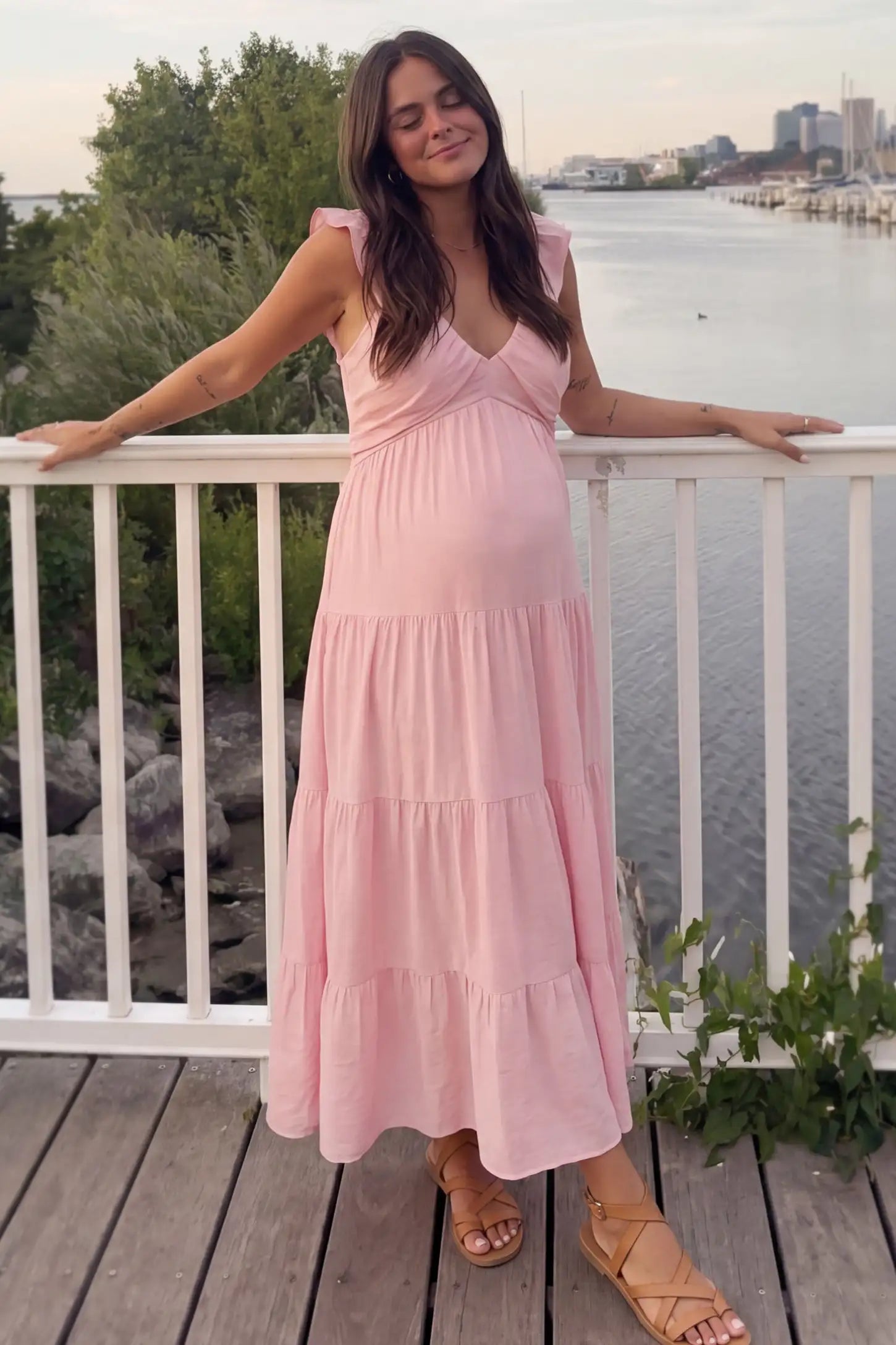 Ruffled Sleeve V-neck A-line Maternity Midi Dress Ruffled sleeve V-neck A-line maternity midi dress in pink with V-neckline and ruffled sleeves, front view on pregnant model