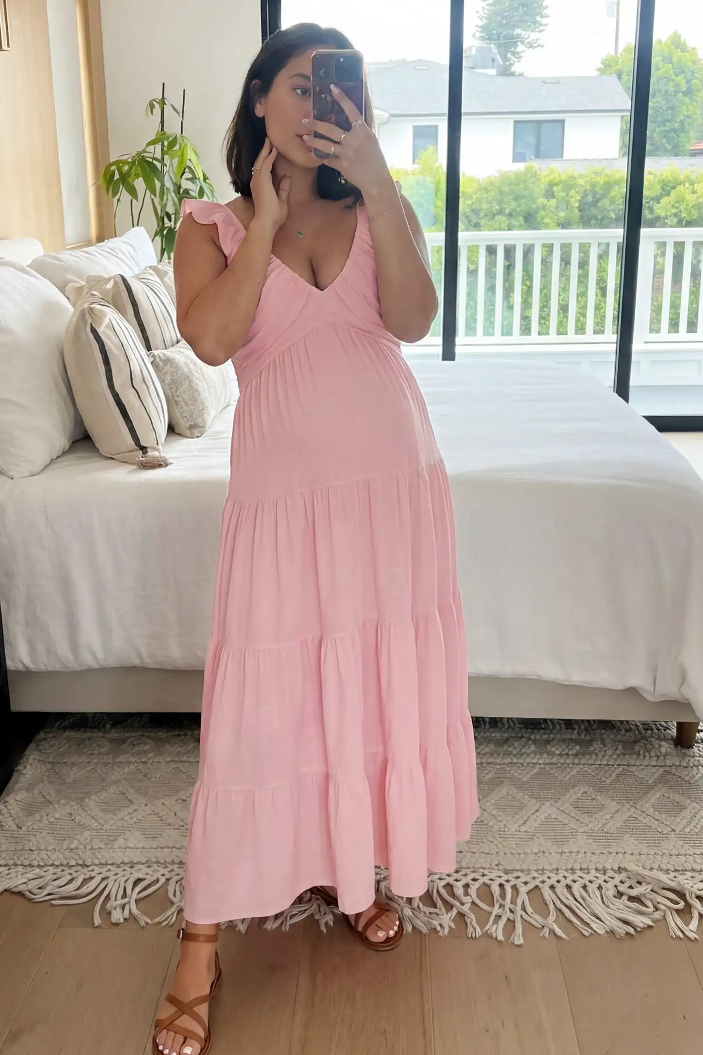 Ruffled Sleeve V-neck A-line Maternity Midi Dress Ruffled sleeve V-neck A-line maternity midi dress in pink with V-neckline and ruffled sleeves, front view on pregnant model