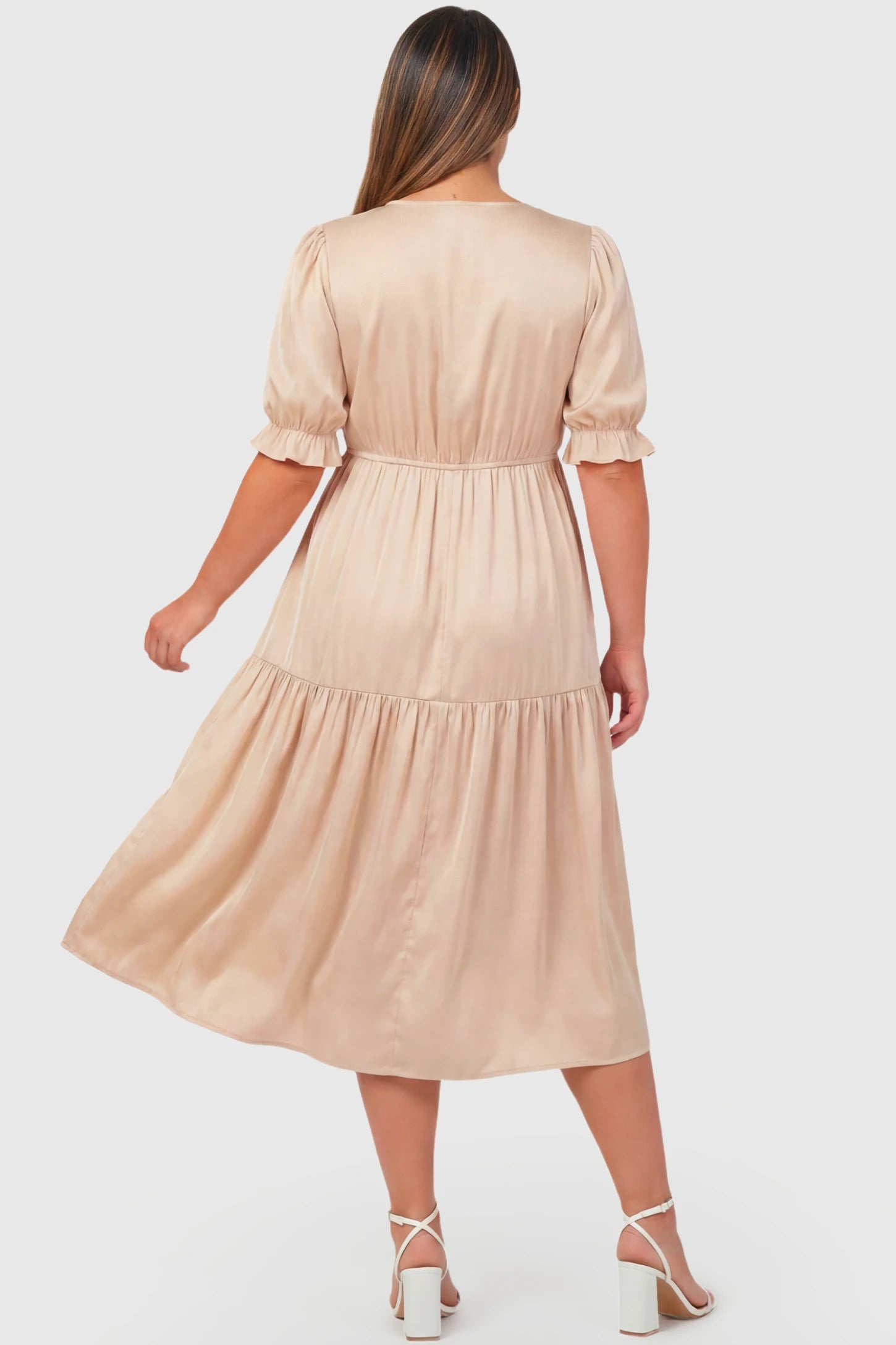 Tiered Hem A-Line Maternity Midi Dress Tiered Hem A-Line Maternity Midi Dress in apricot featuring empire waist, elbow-length puff sleeves, and flowy skirt on pregnant model.