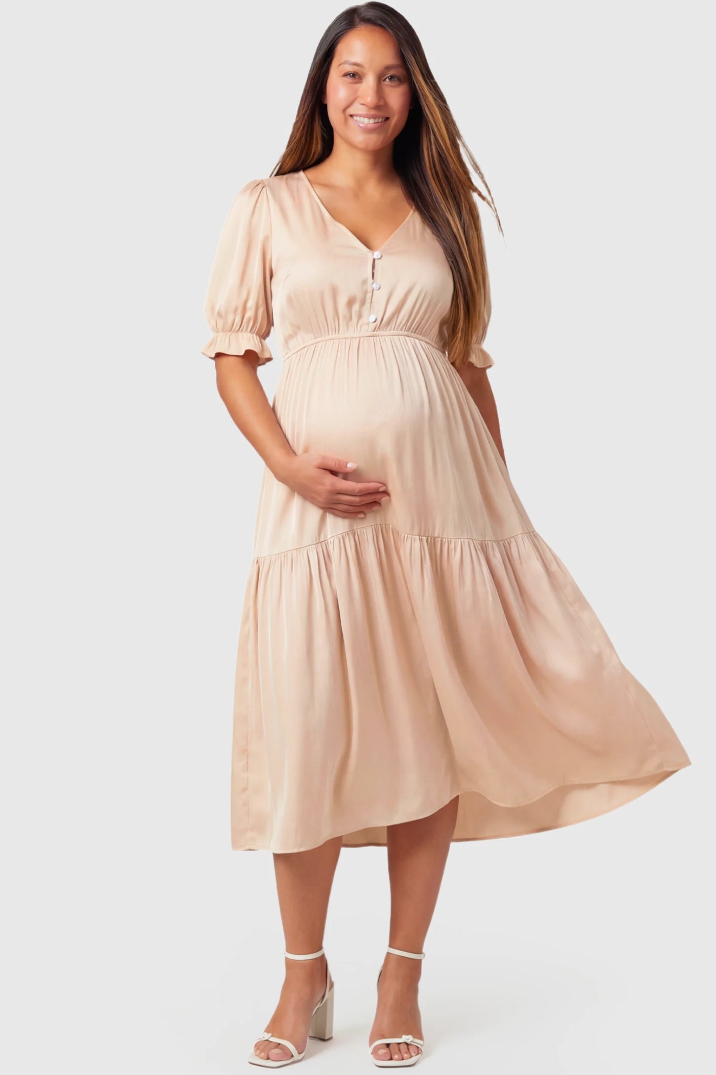 Tiered Hem A-Line Maternity Midi Dress Tiered Hem A-Line Maternity Midi Dress in apricot featuring empire waist, elbow-length puff sleeves, V-neckline, and flowy skirt on pregnant model.