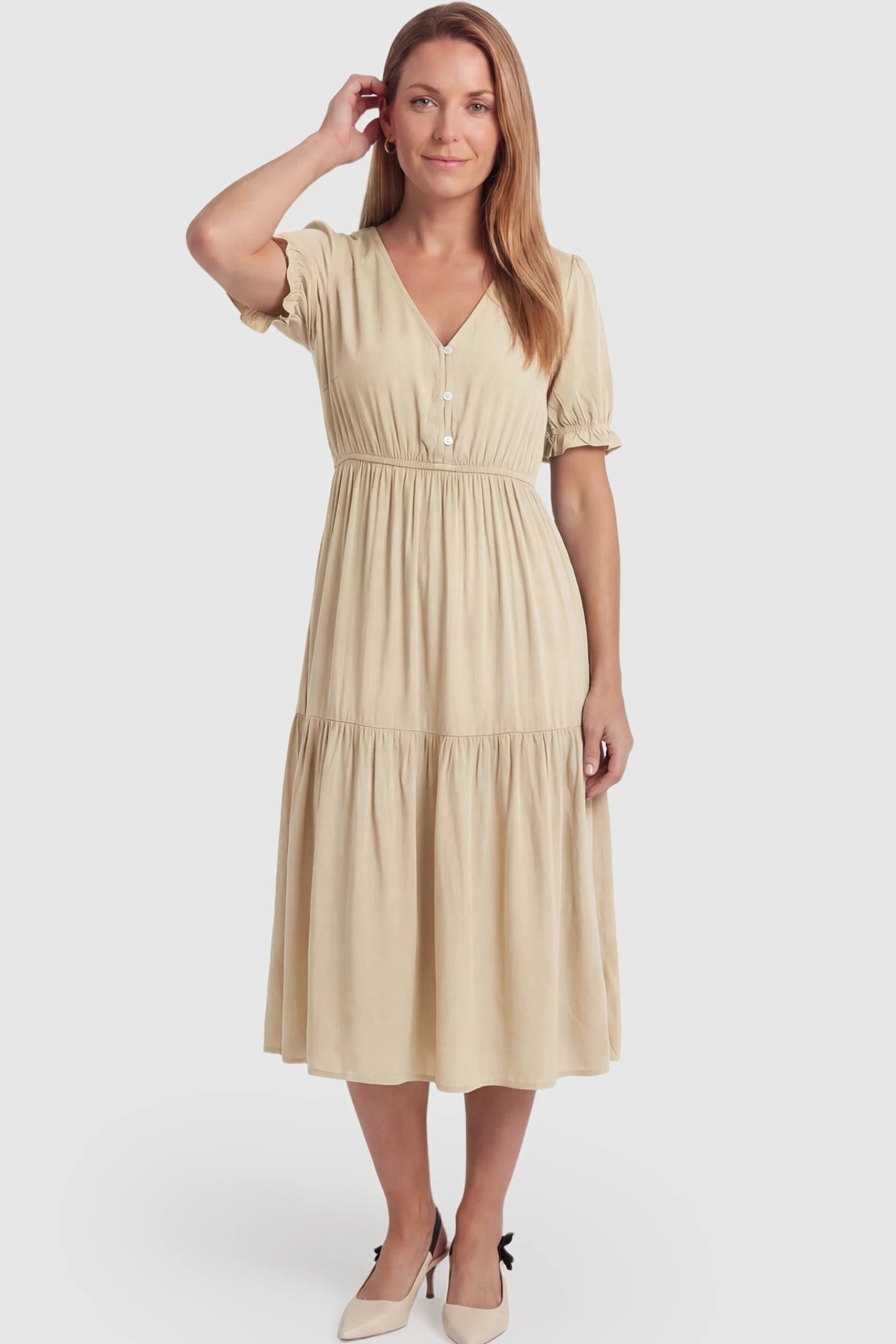 Tiered Hem A-Line Maternity Midi Dress Tiered Hem A-Line Maternity Midi Dress in apricot featuring empire waist, elbow-length puff sleeves, V-neckline, and flowy skirt on non pregnant model.