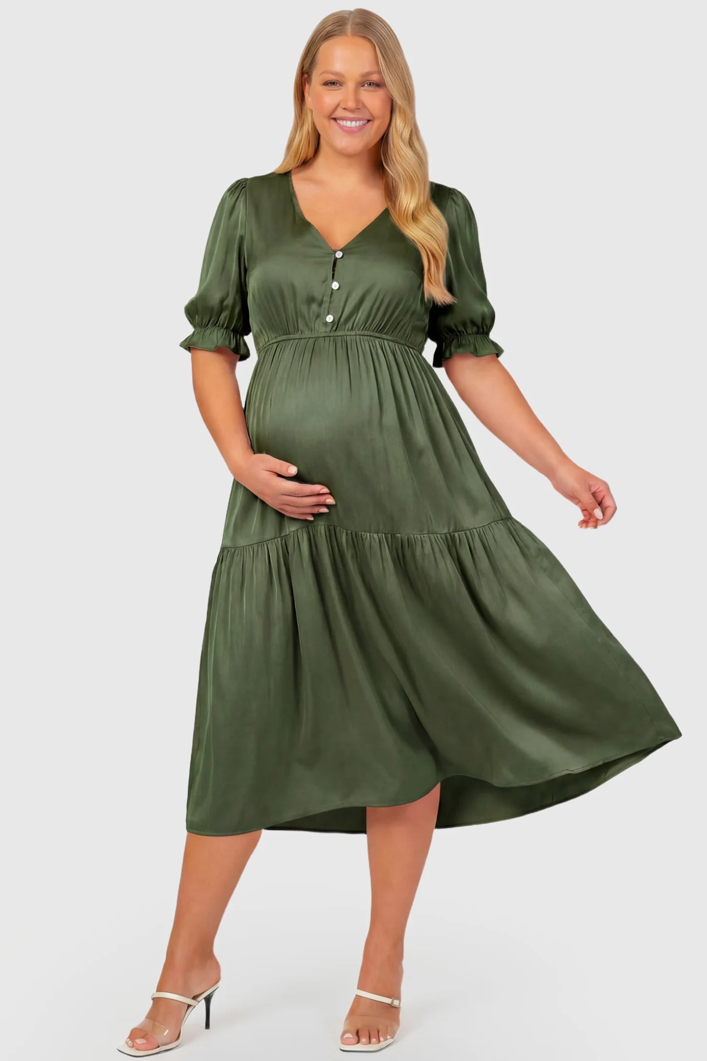 Tiered Hem A-Line Maternity Midi Dress Tiered Hem A-Line Maternity Midi Dress in army green featuring empire waist, elbow-length puff sleeves, V-neckline, and flowy skirt on plus size pregnant model.