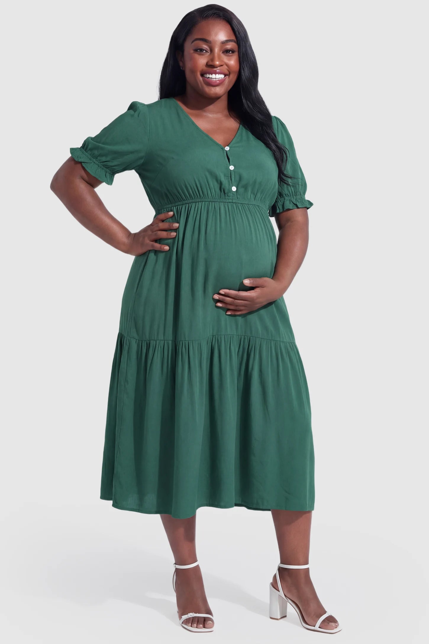 Tiered Hem A-Line Maternity Midi Dress Tiered Hem A-Line Maternity Midi Dress in army green featuring empire waist, elbow-length puff sleeves, V-neckline, and flowy skirt on plus size pregnant model.