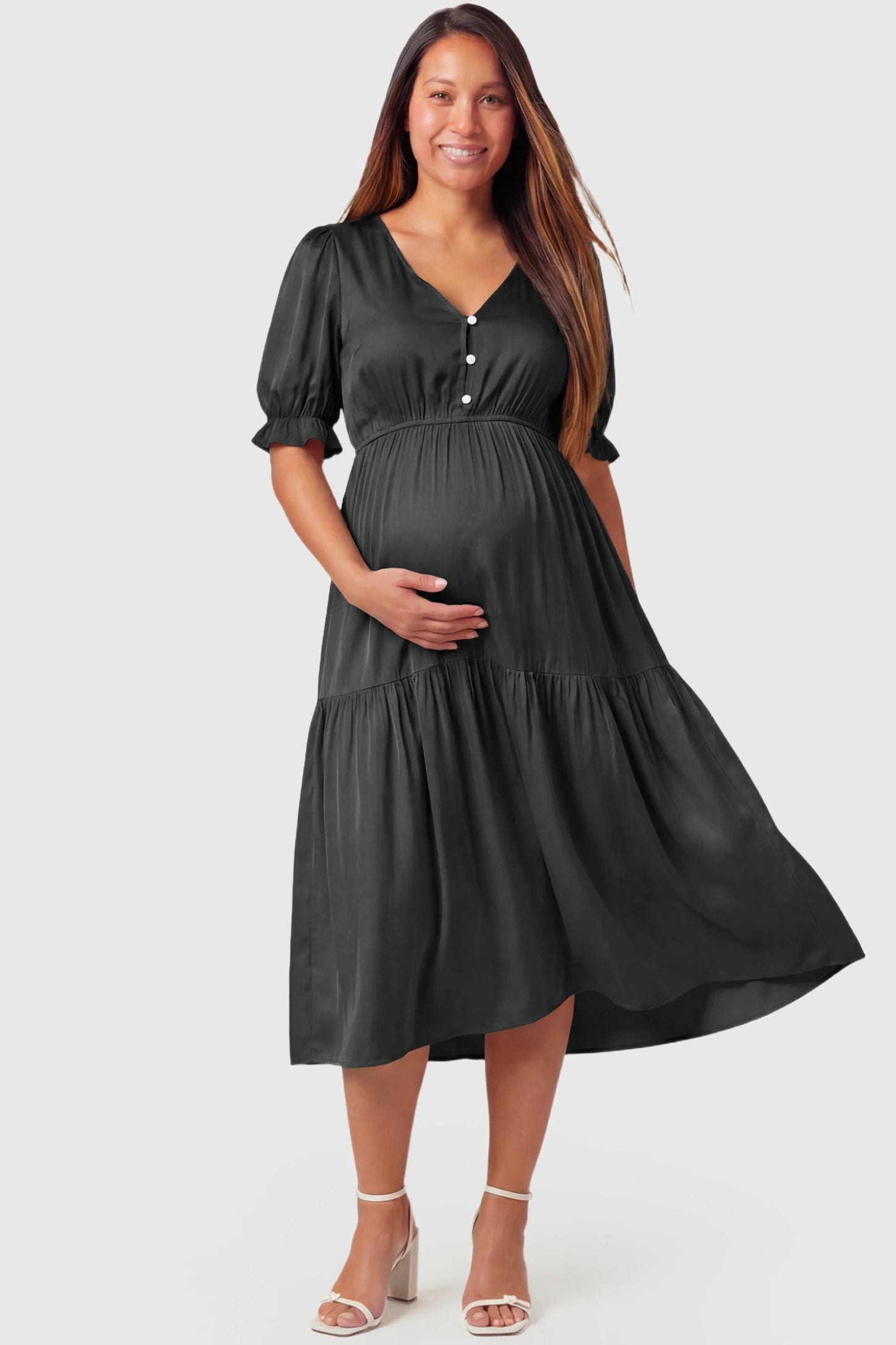 Tiered Hem A-Line Maternity Midi Dress Tiered Hem A-Line Maternity Midi Dress in black featuring empire waist, elbow-length puff sleeves, V-neckline, and flowy skirt on pregnant model.