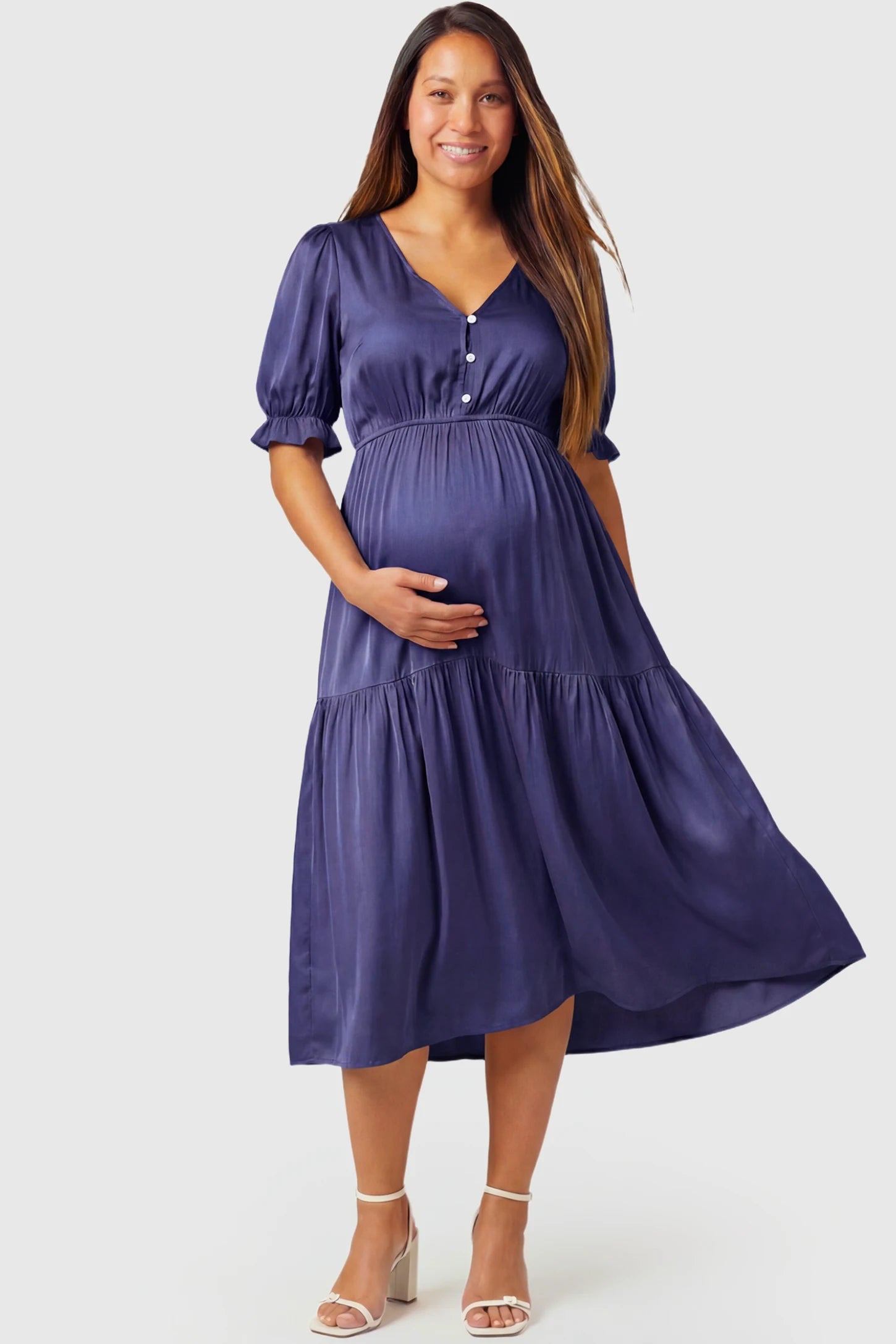 Tiered Hem A-Line Maternity Midi Dress Tiered Hem A-Line Maternity Midi Dress in navy blue featuring empire waist, elbow-length puff sleeves, V-neckline, and flowy skirt on pregnant model.
