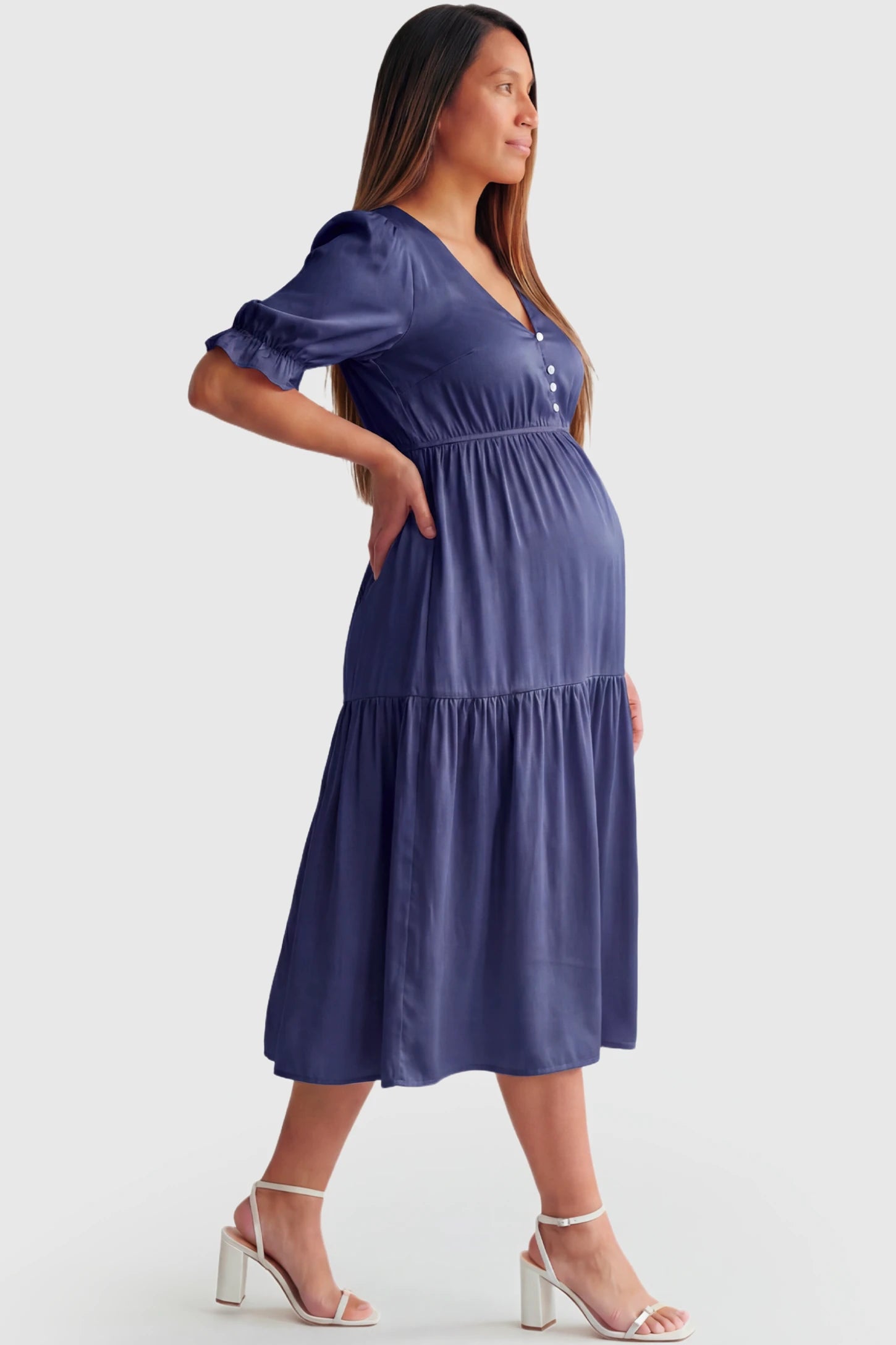 Tiered Hem A-Line Maternity Midi Dress Tiered Hem A-Line Maternity Midi Dress in navy blue featuring empire waist, elbow-length puff sleeves, V-neckline, and flowy skirt on pregnant model.