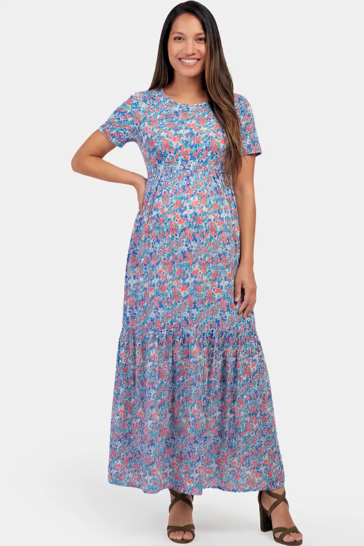Floral A-Line Maternity Maxi Dress in floral blue print featuring empire waist and tiered hem a pregnant model.
