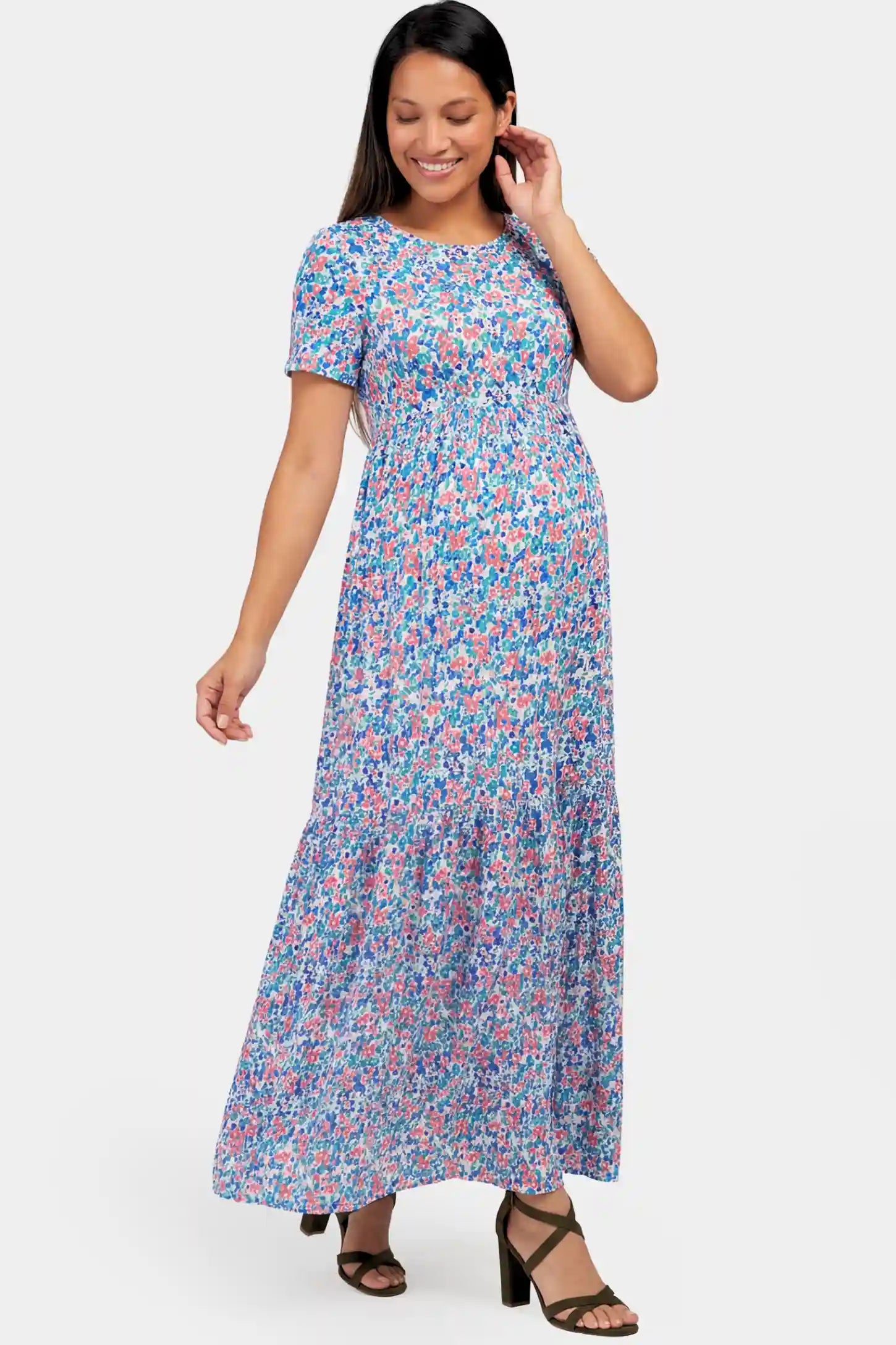 Floral A-Line Maternity Maxi Dress Floral A-Line Maternity Maxi Dress in floral blue print featuring empire waist and tiered hem a pregnant model.