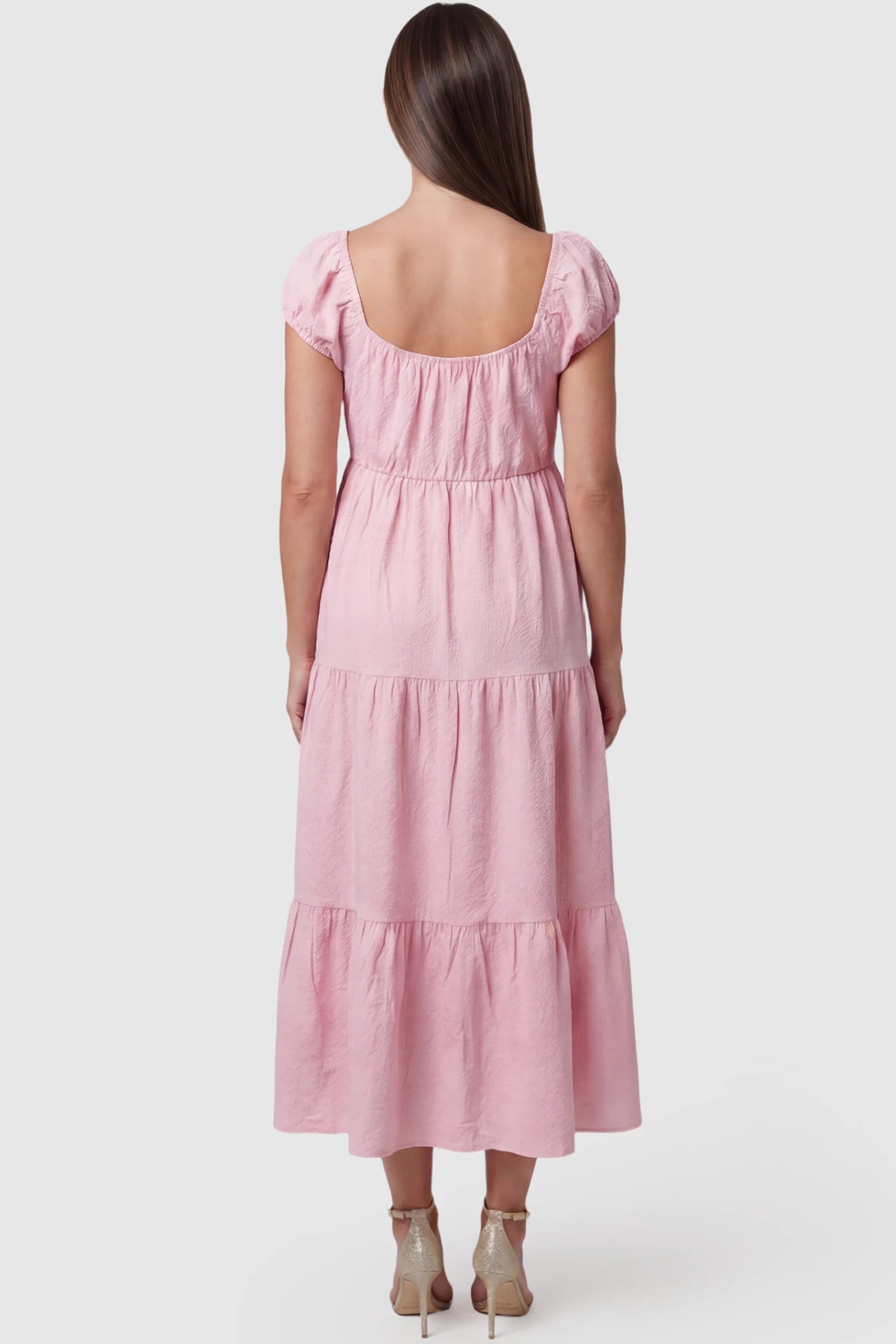 Short Puff Sleeve Tiered Maternity Maxi Dress Short Puff Sleeve Tiered Maternity Maxi Dress in pink featuring short sleeves and tiered maternity dress on a pregnant model showing back.