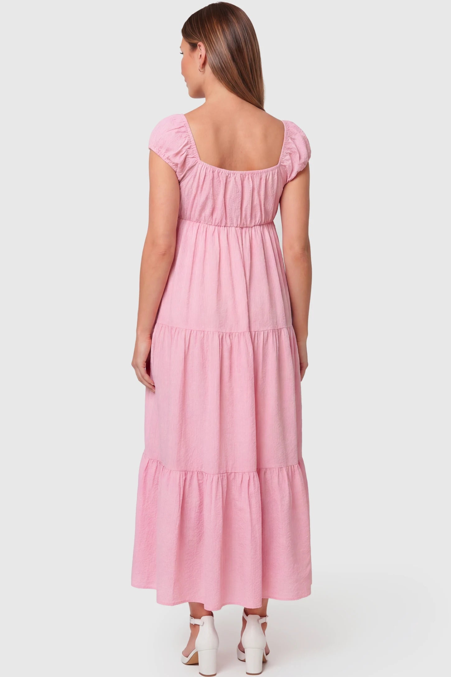 Short Puff Sleeve Tiered Maternity Maxi Dress Short Puff Sleeve Tiered Maternity Maxi Dress in pink featuring an empire waist on a pregnant model.