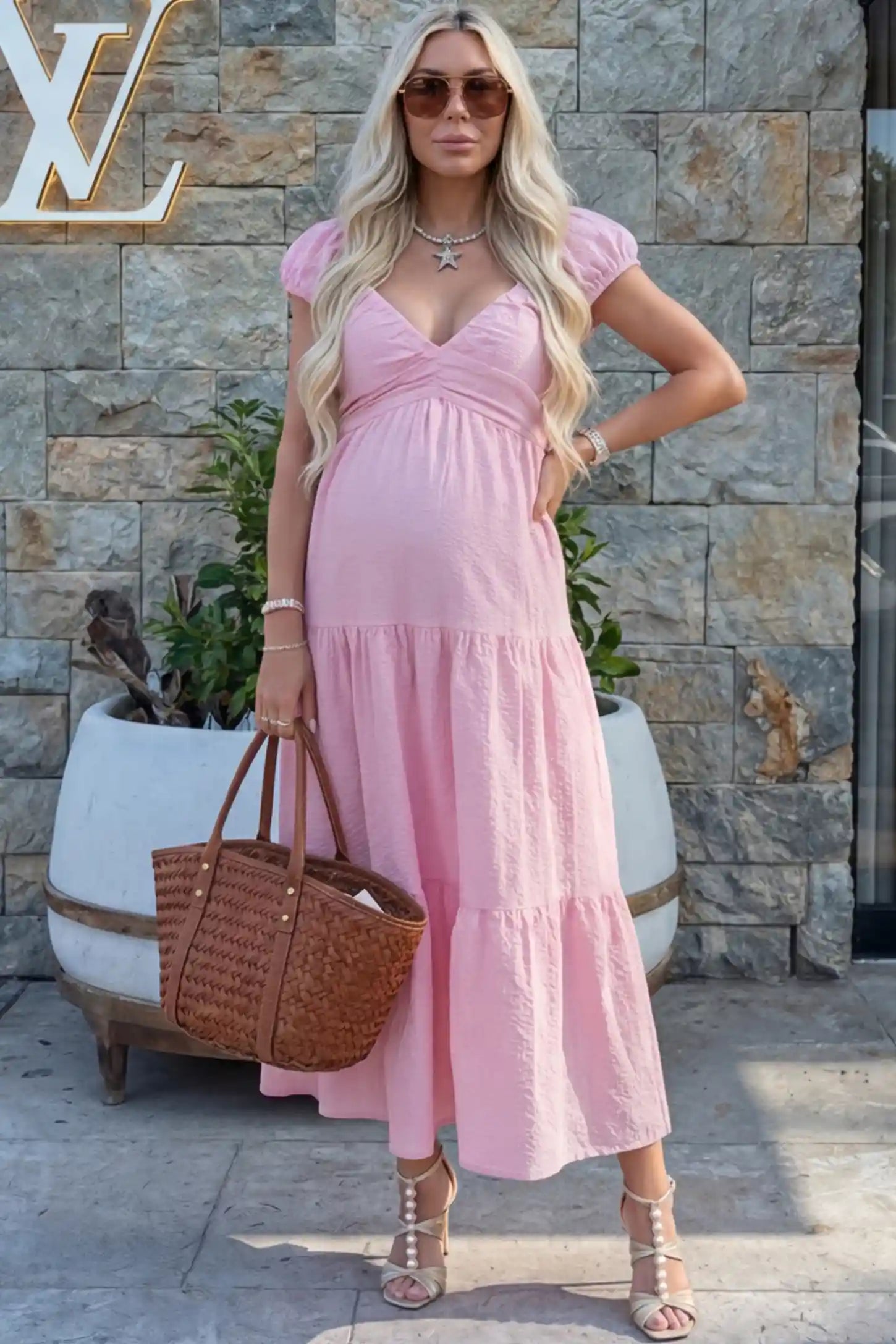 Short Puff Sleeve Tiered Maternity Maxi Dress Short Puff Sleeve Tiered Maternity Maxi Dress in pink featuring short sleeves and tiered maternity dress on a pregnant woman during outdoor photoshoot showing front.