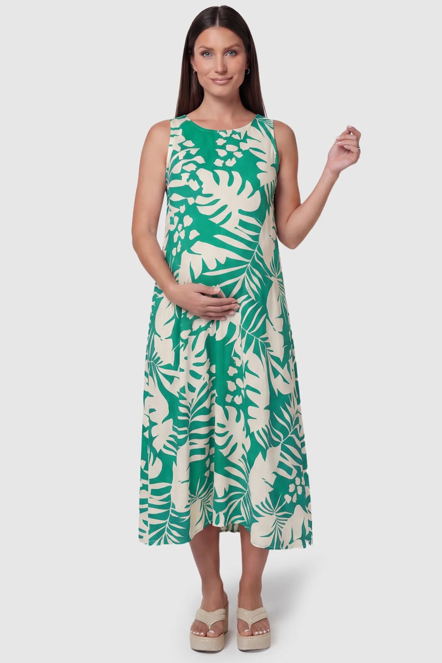 Tropical Print V-Back Sleeveless Midi Maternity Dress Green Tropical Print V-Back Sleeveless Midi Maternity Dress front view featuring a bold leaf pattern on a pregnant model.