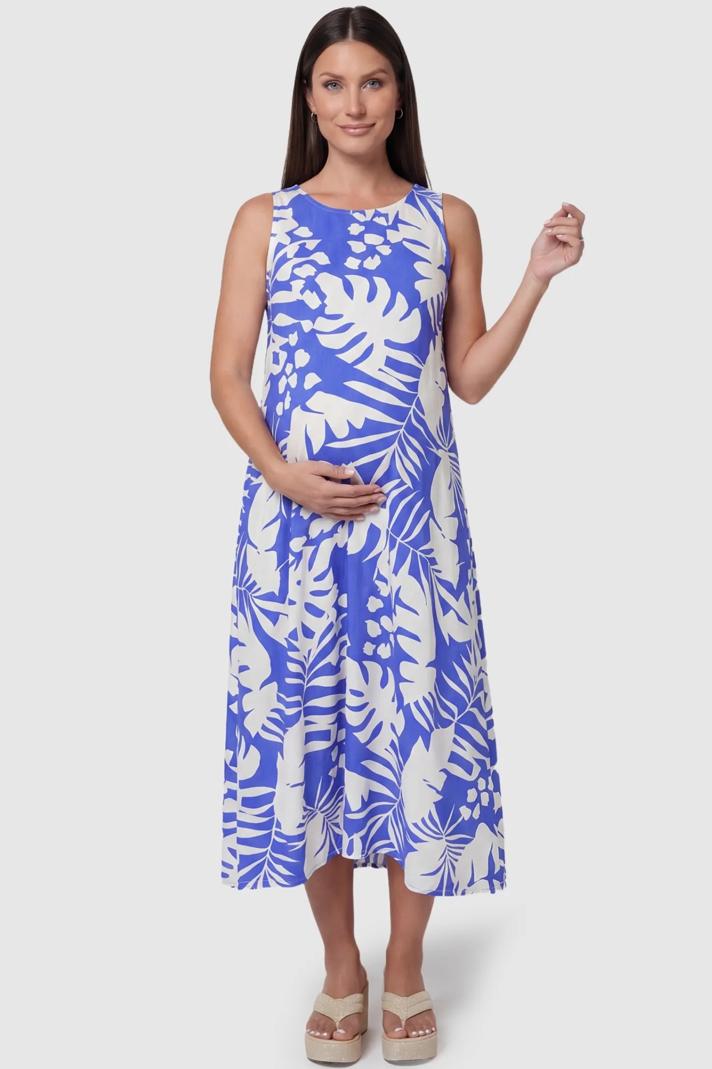 Blue Tropical Print V-Back Sleeveless Midi Maternity Dress front view featuring a high neckline on a pregnant model.